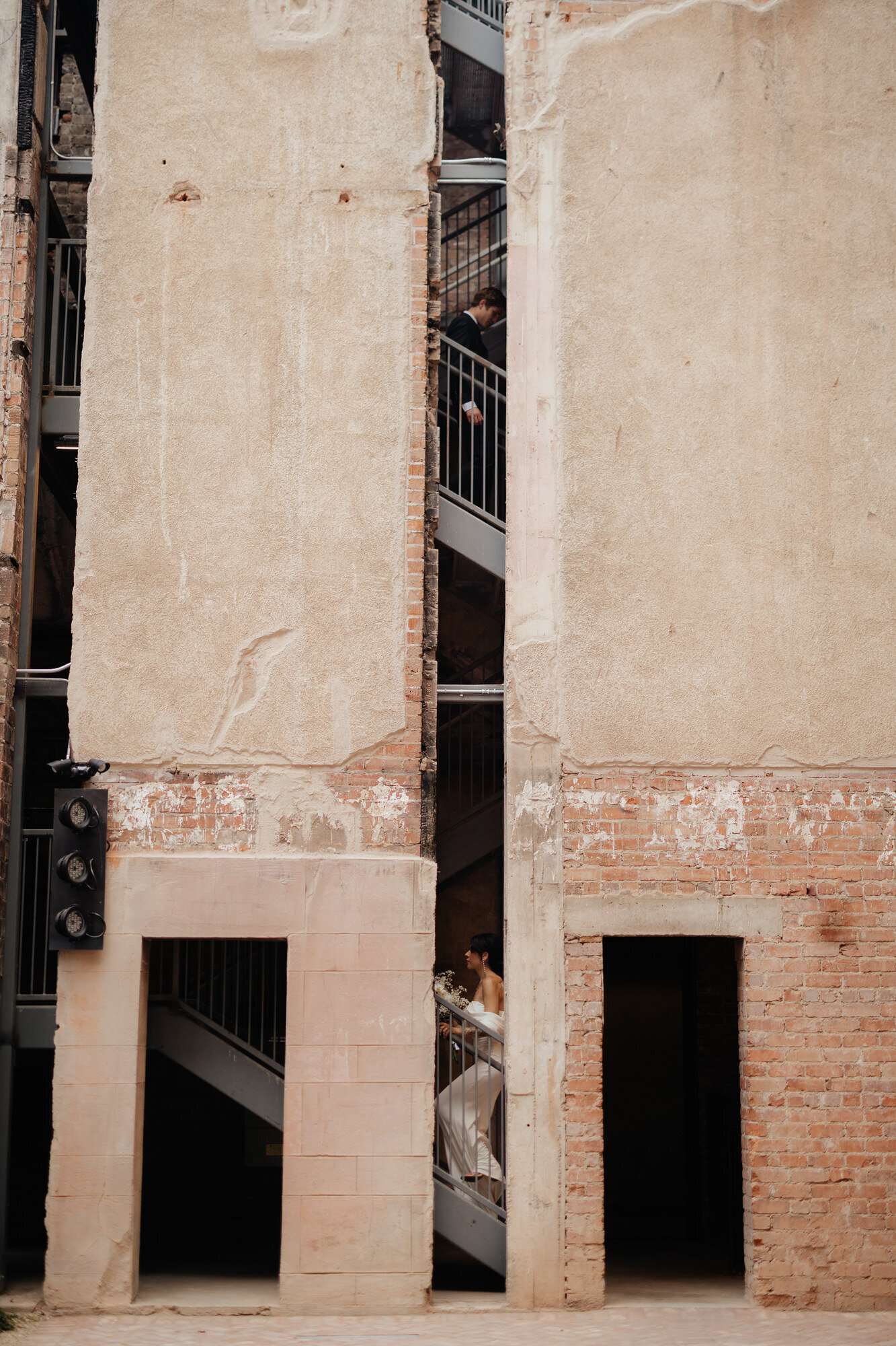 Bride and groom walking towards each other on stairs at the Abbey on Monroe taken by Arizona wedding photographer