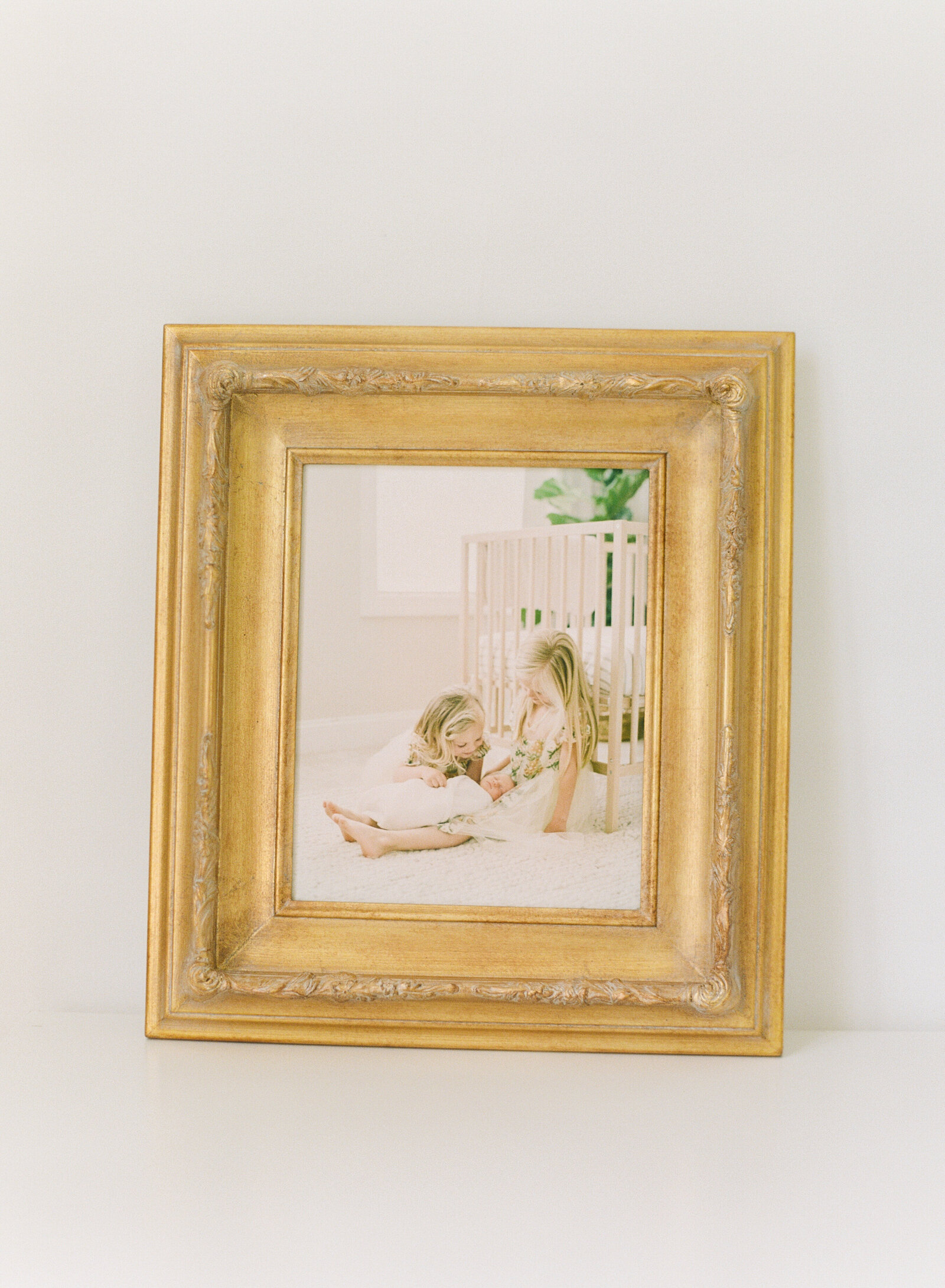 Gold framed canvas of a Raleigh newborn session by Raleigh family photographers A.J. Dunlap Photography
