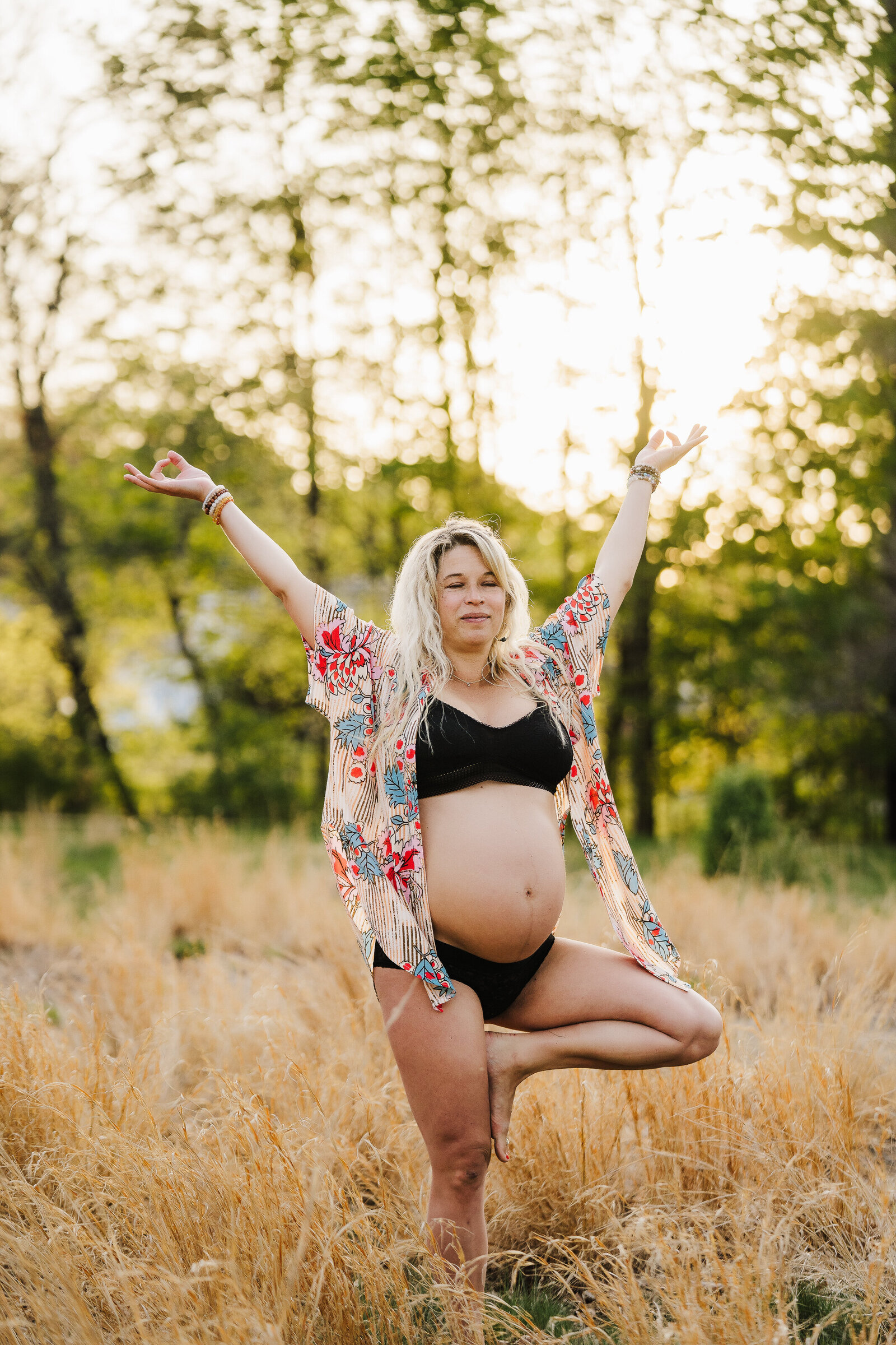 pregnant woman does yoga in field