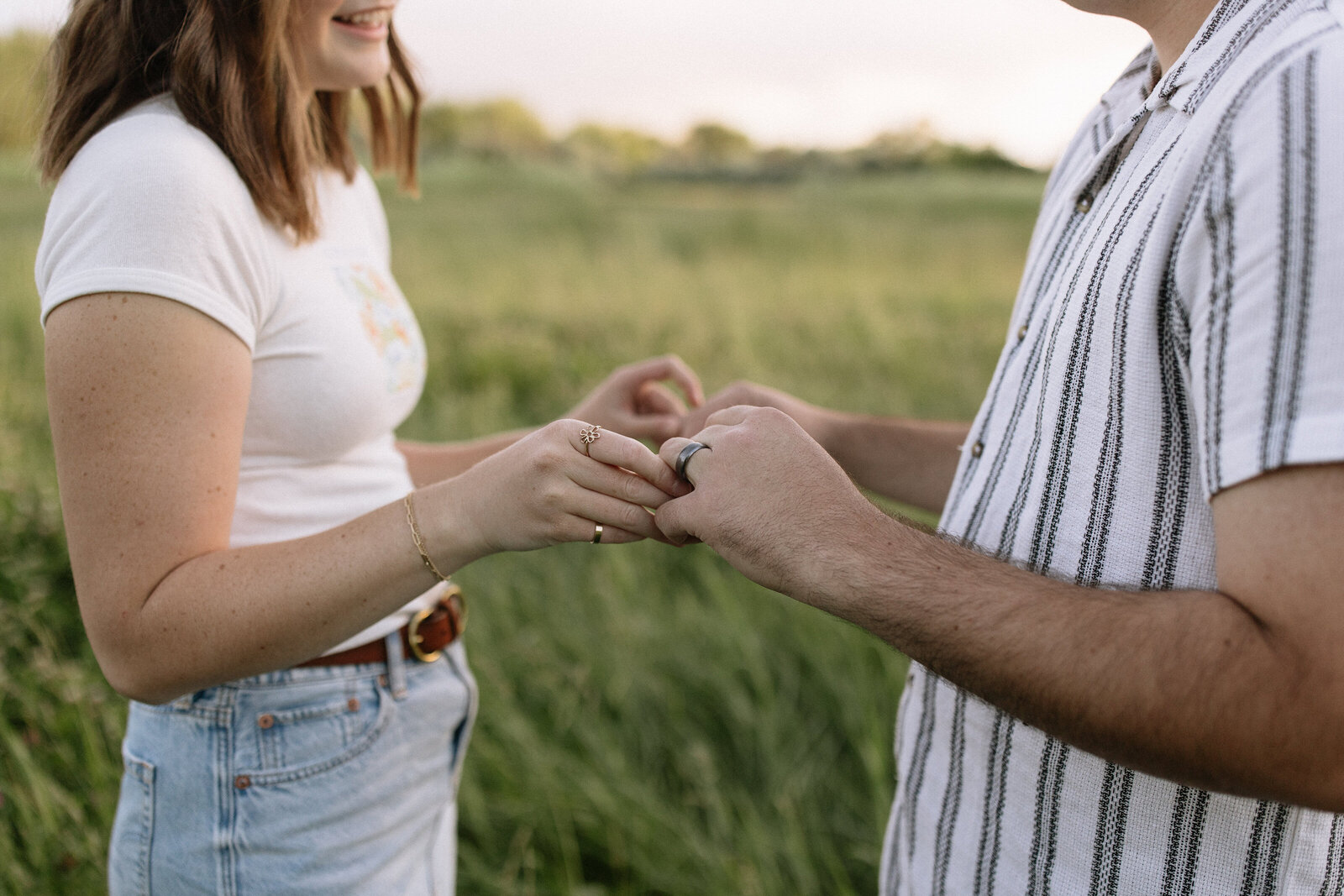 Close-up photo of intertwined hands during soft Cascade sunset session