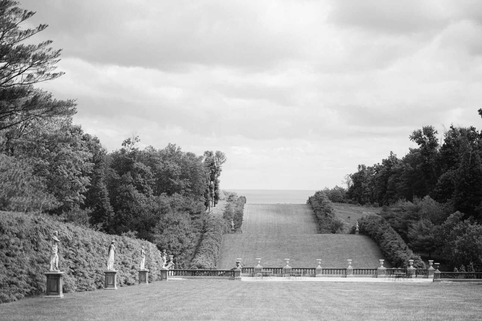 overhead photo of bride and groom kissing on a bridge