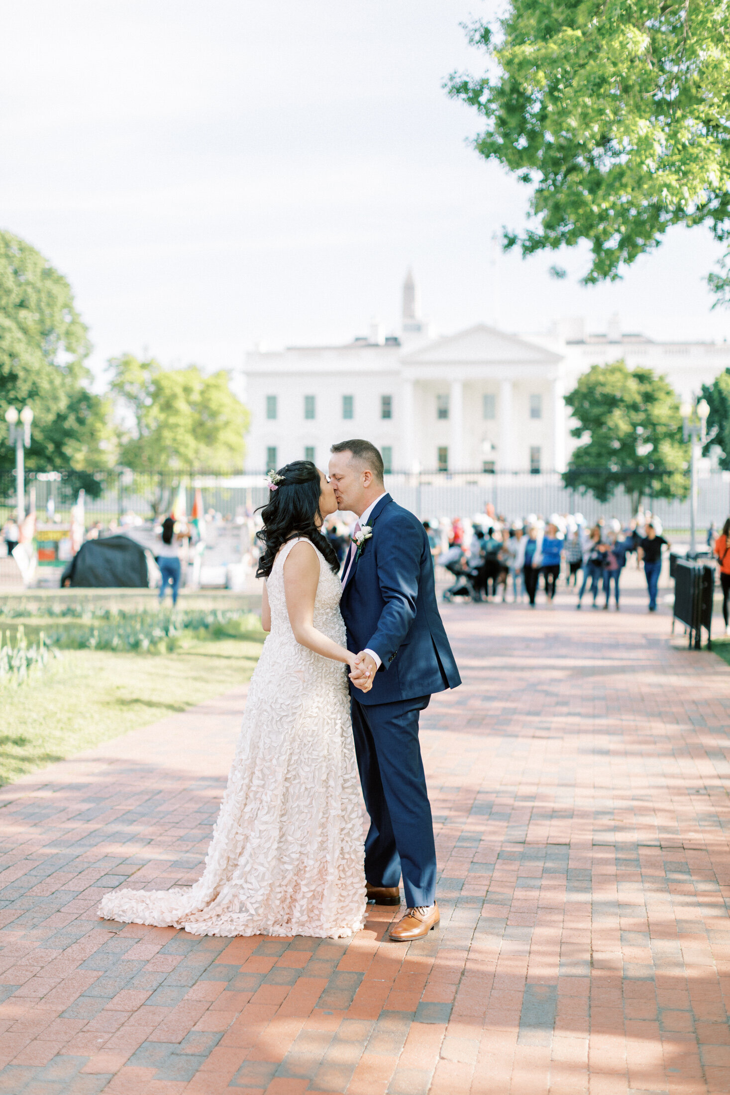 Bride and groom kiss in front of the White House in DC