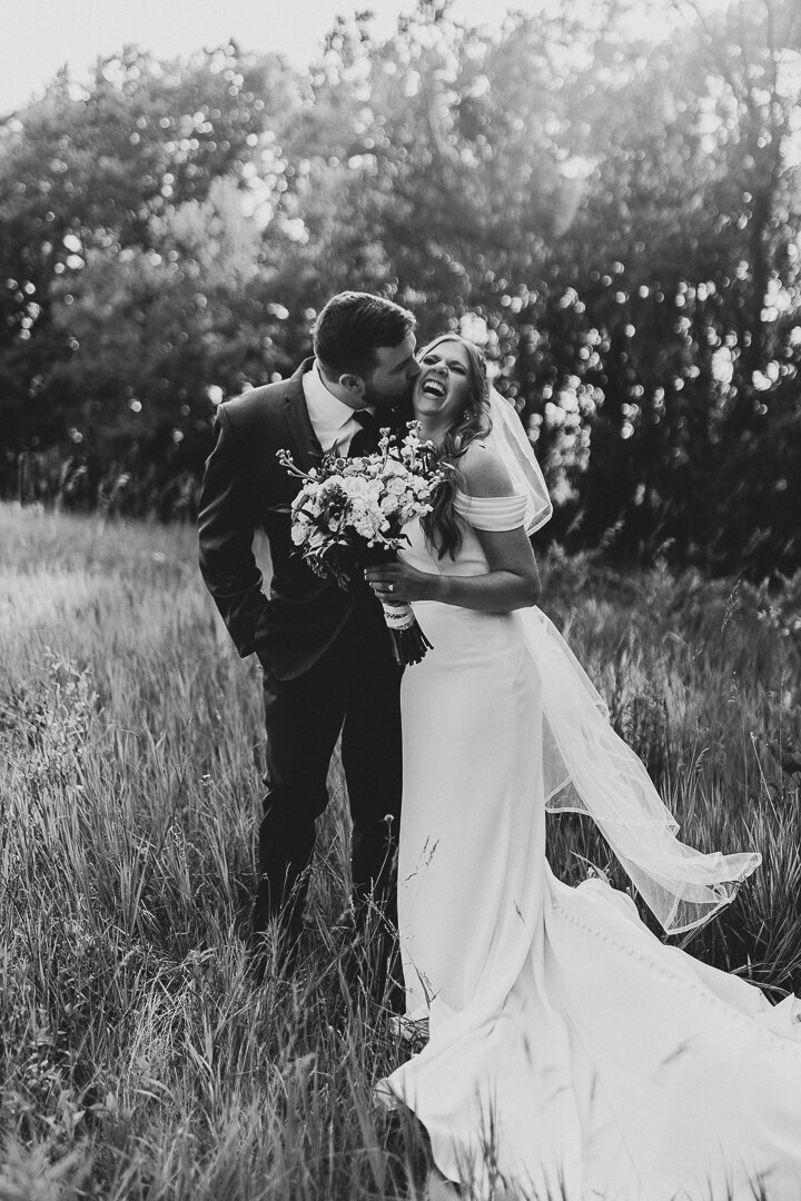 Red Acre Barn Iowa wedding couple laughing in field