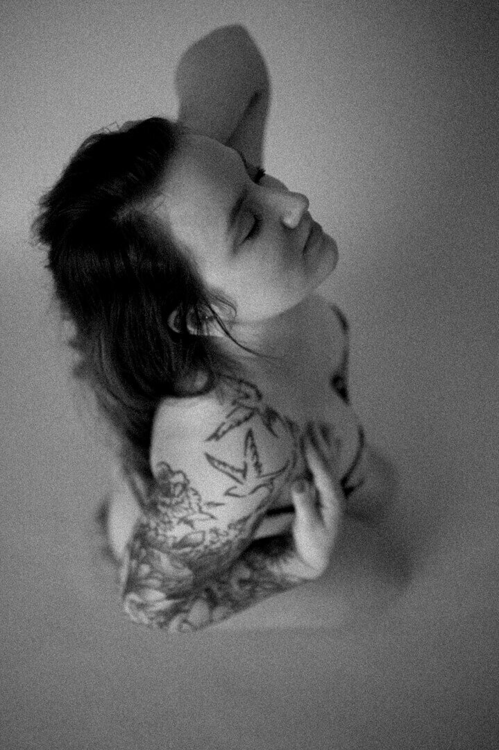 tattooed woman leaning back