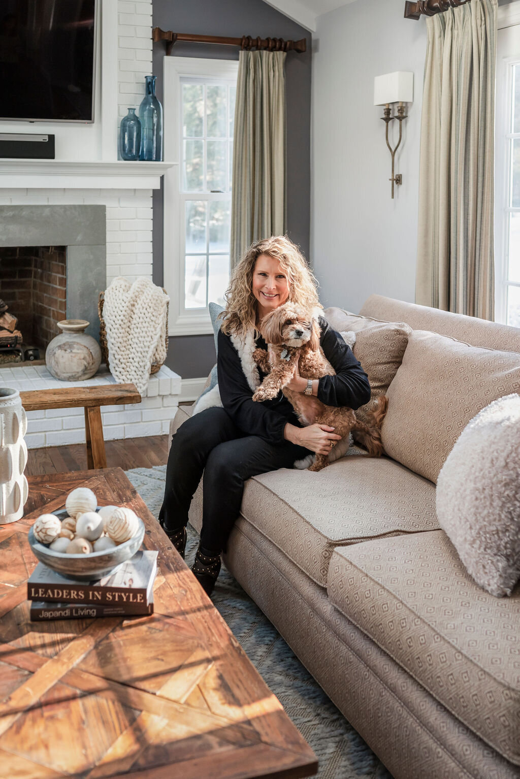 Donna Restaino Levey  in living room with her dog