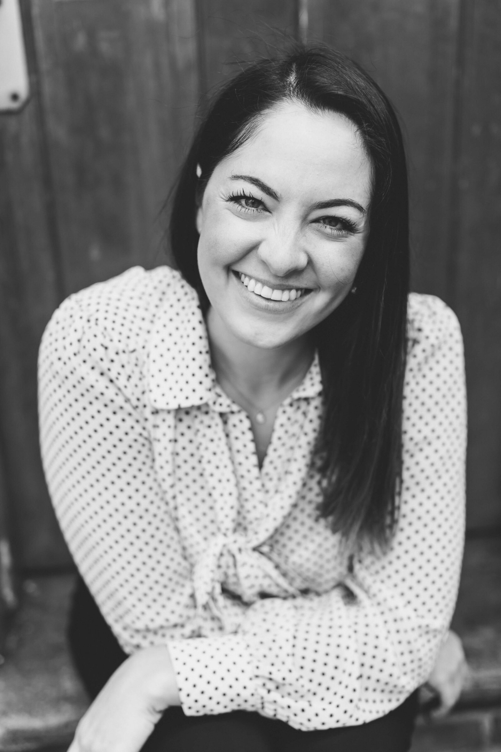 black and white photo of women with dark hair smiling at the camera