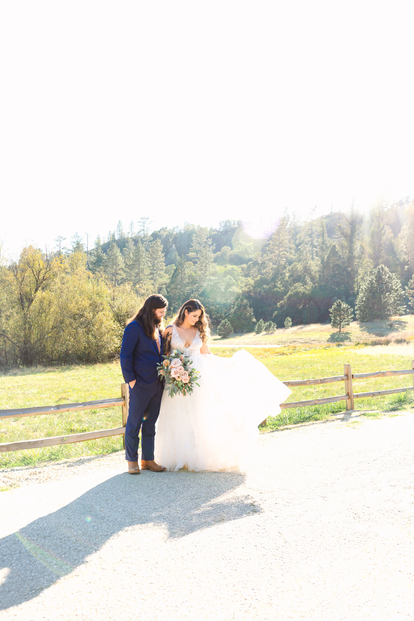 Tattoo bride and groom embrace on their colorful wedding day in Santa Cruz, California.