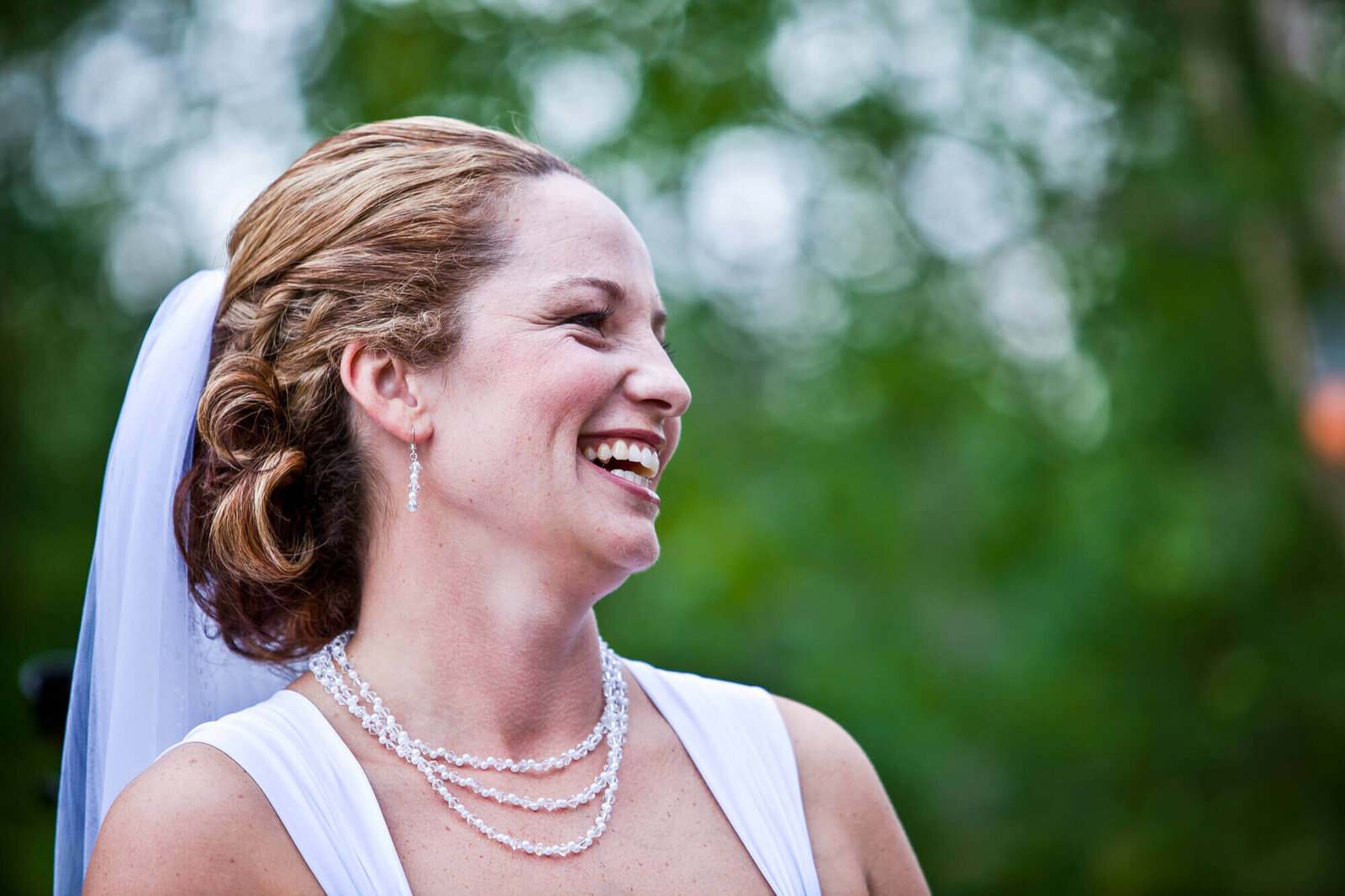 gorgeous bride laughing as groom  reminds her of a funny story