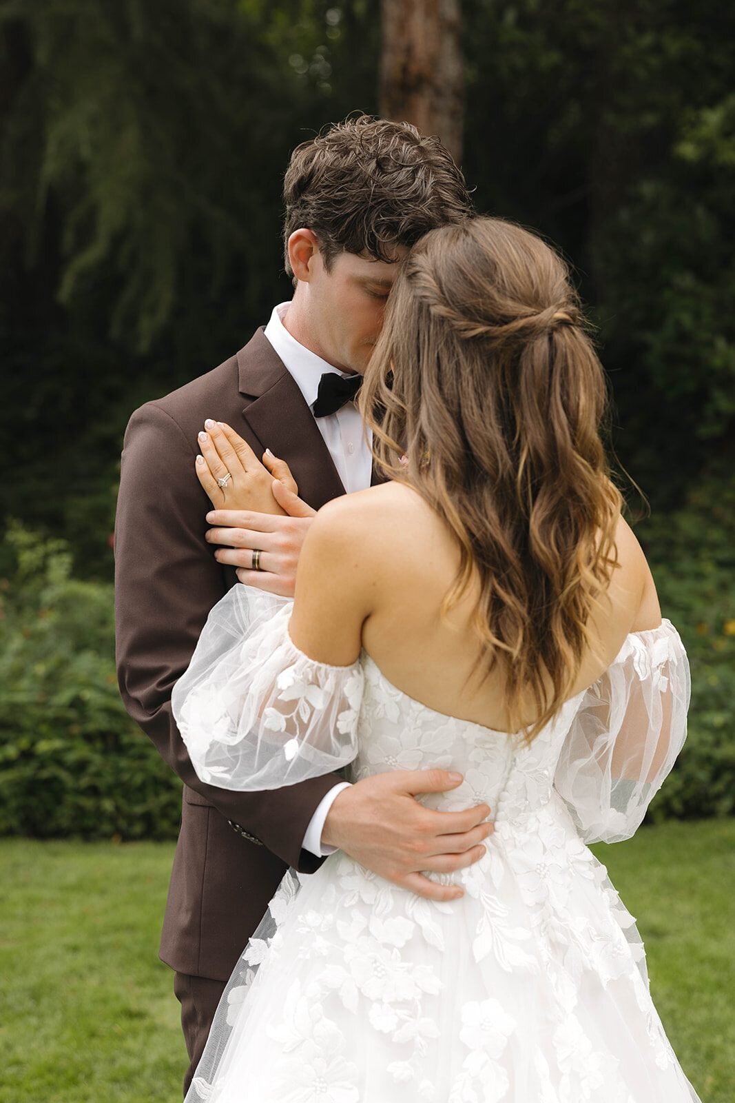 Bride and groom embracing in the garden