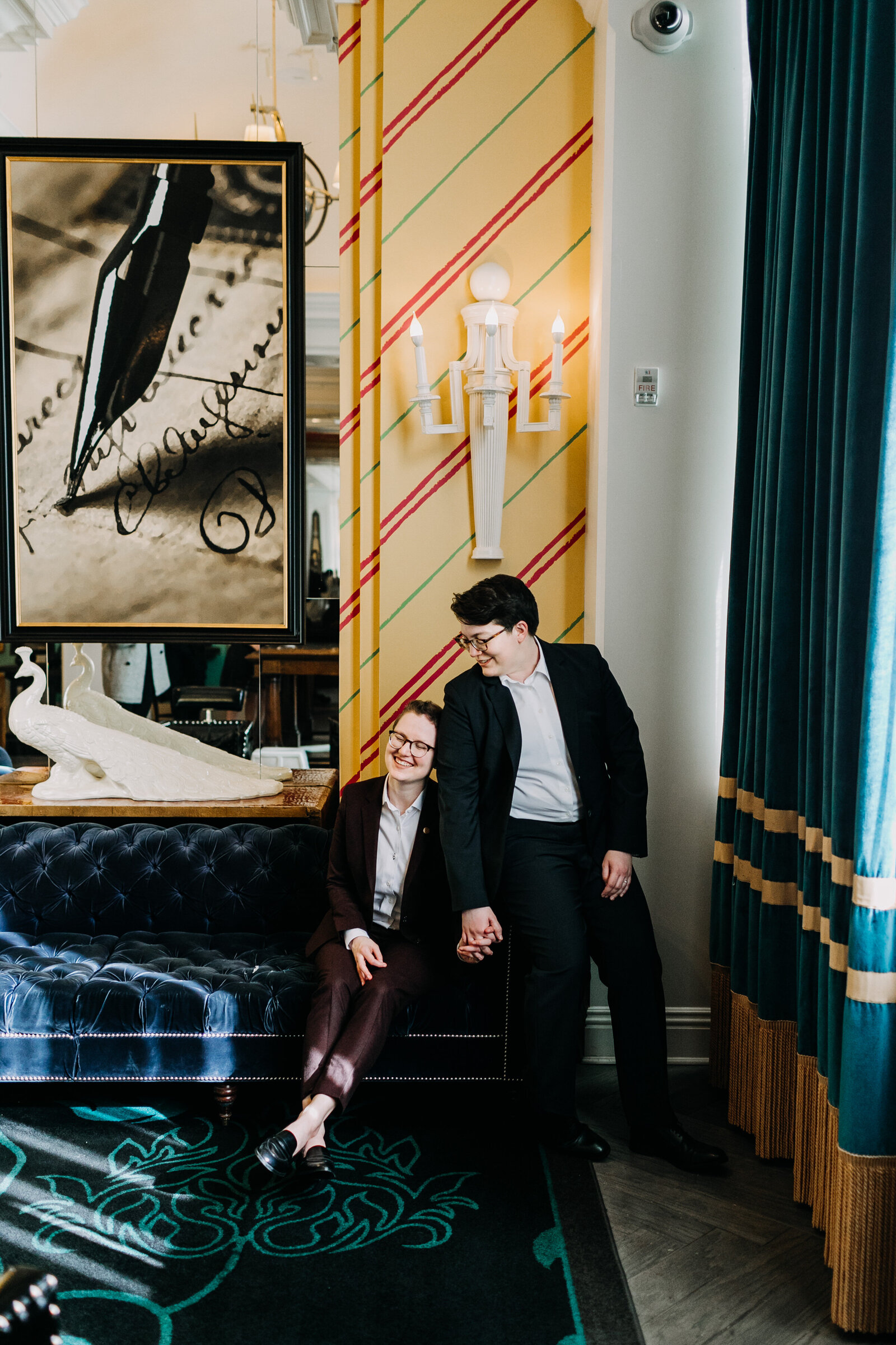 gay brides suits in colorful hotel lobby