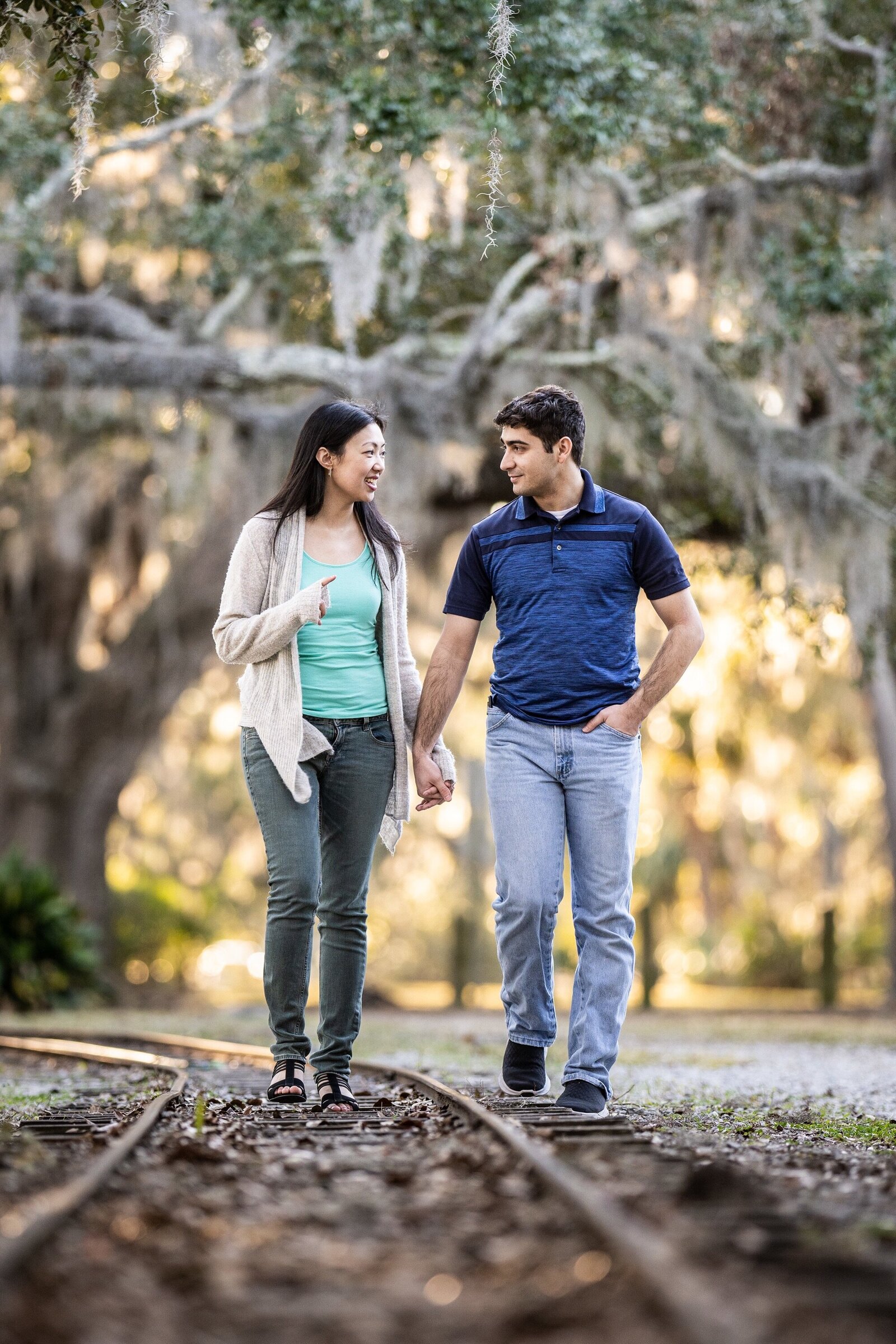 Couple walking along kiddie railroad tracks in New Orleans City Park