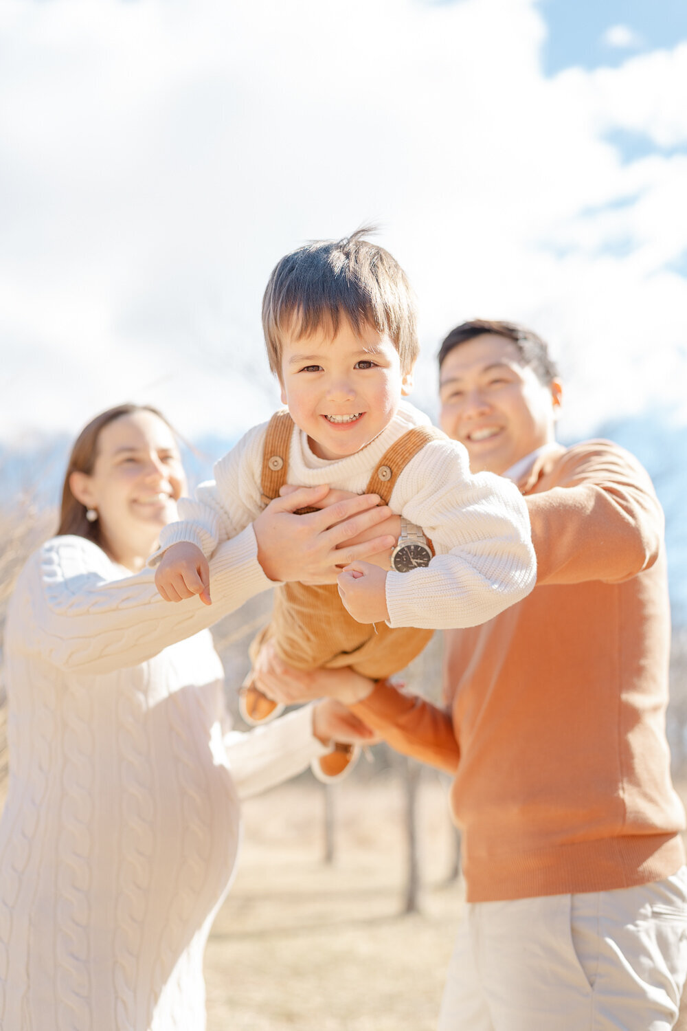 expecting family playing, big brother has big smile