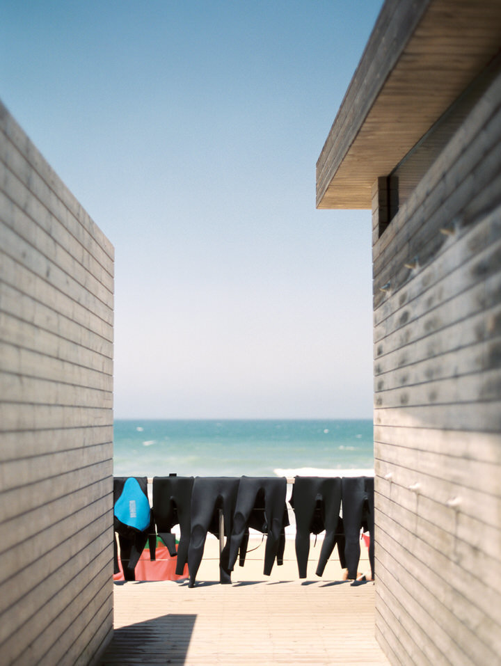 wetsuits hanging to dry at beach club areias do seixo