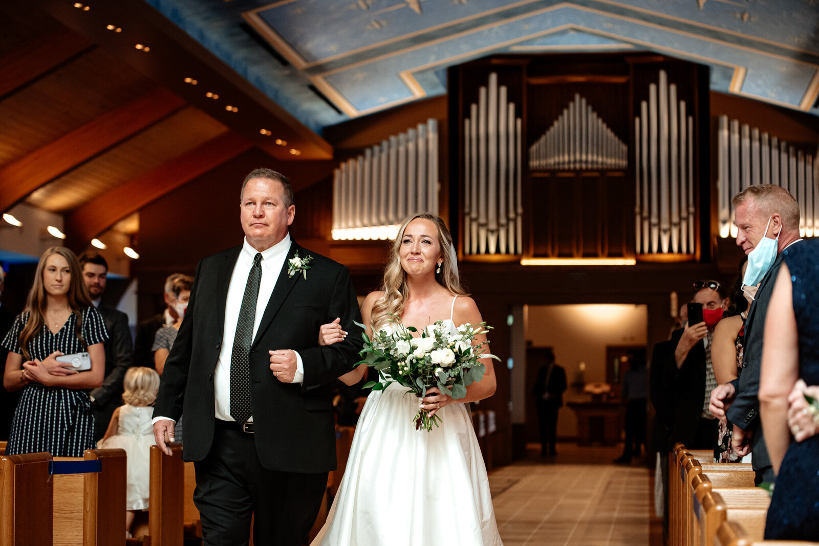 cathedral style wedding with the bride being walked down the aisle by her dad