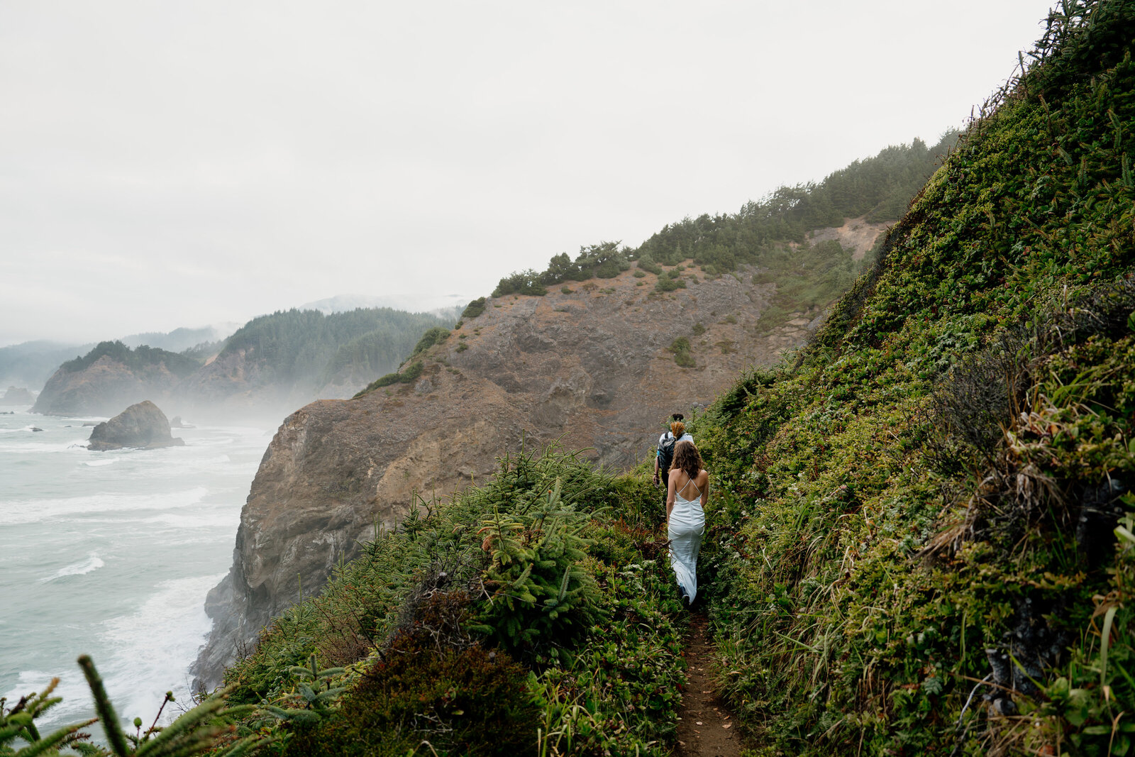 Couple hiking on the Oregon Coast during their adventure elopement near Brookings Oregon.