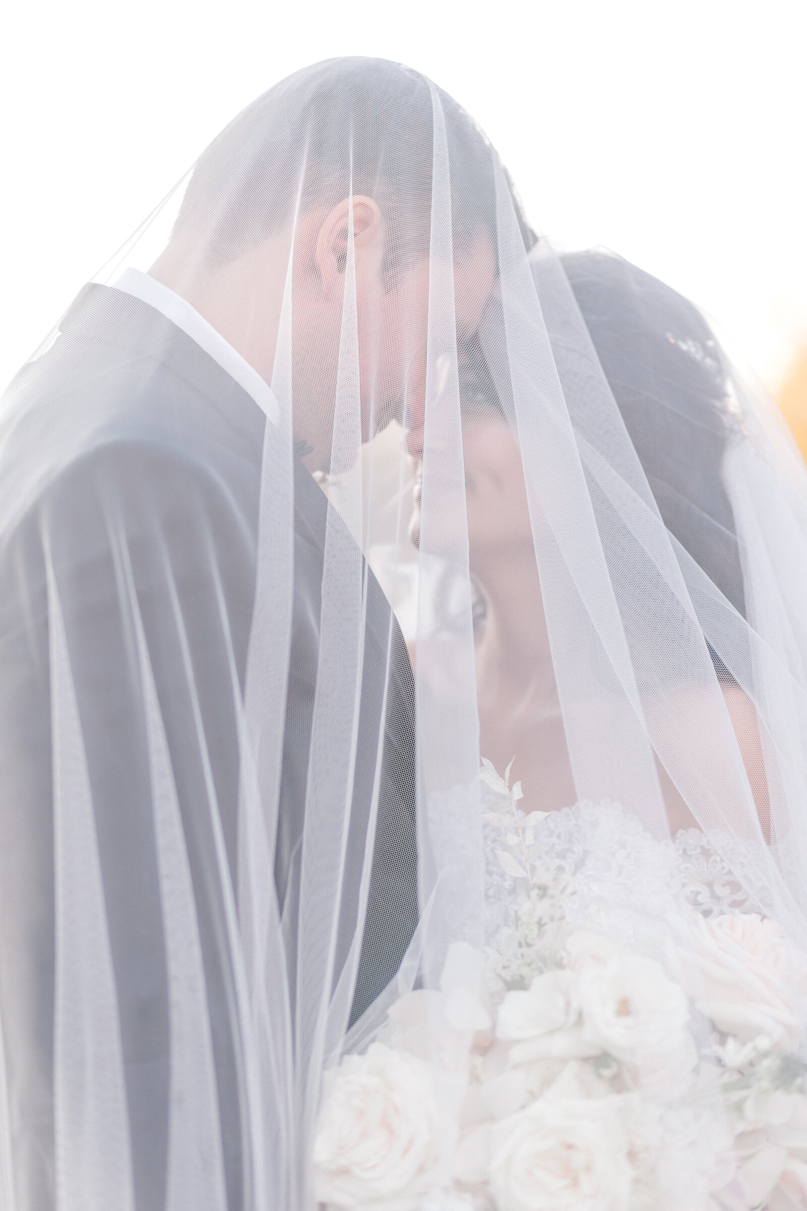 Couple under veil at French Creek Golf Club