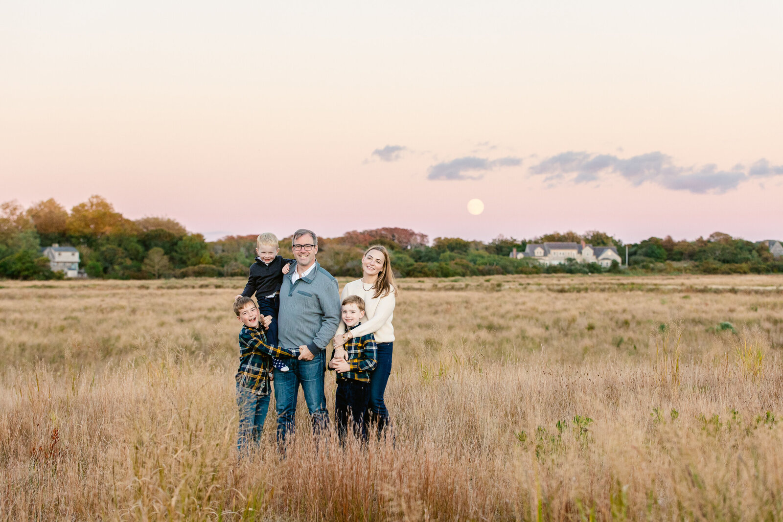 Family in field with full moon