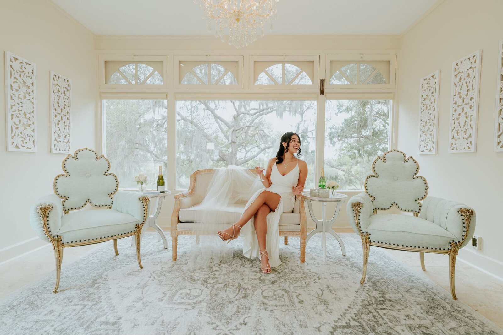 Bride in bridal suite drinking champagne
