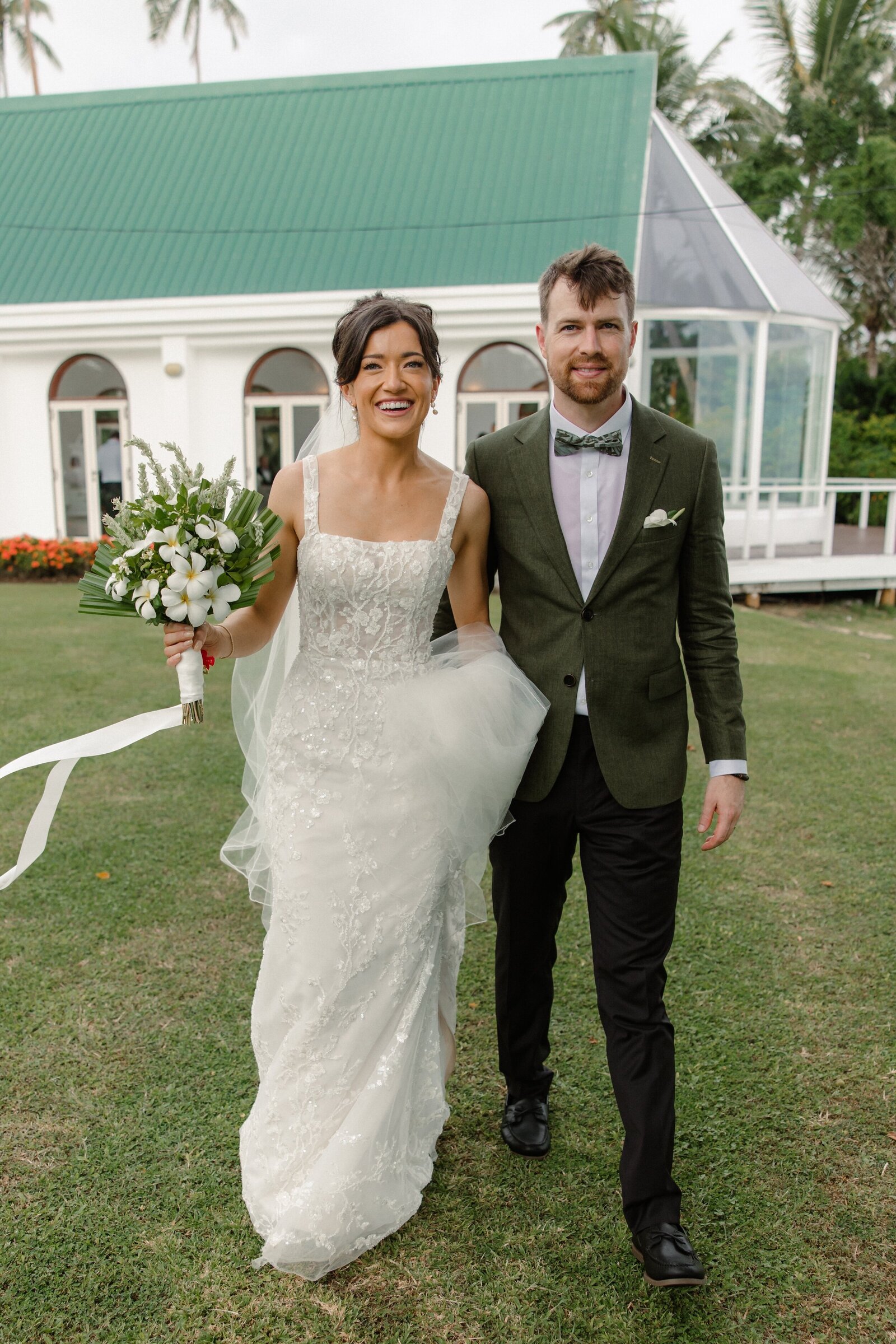 bride and groom walking away from chapel