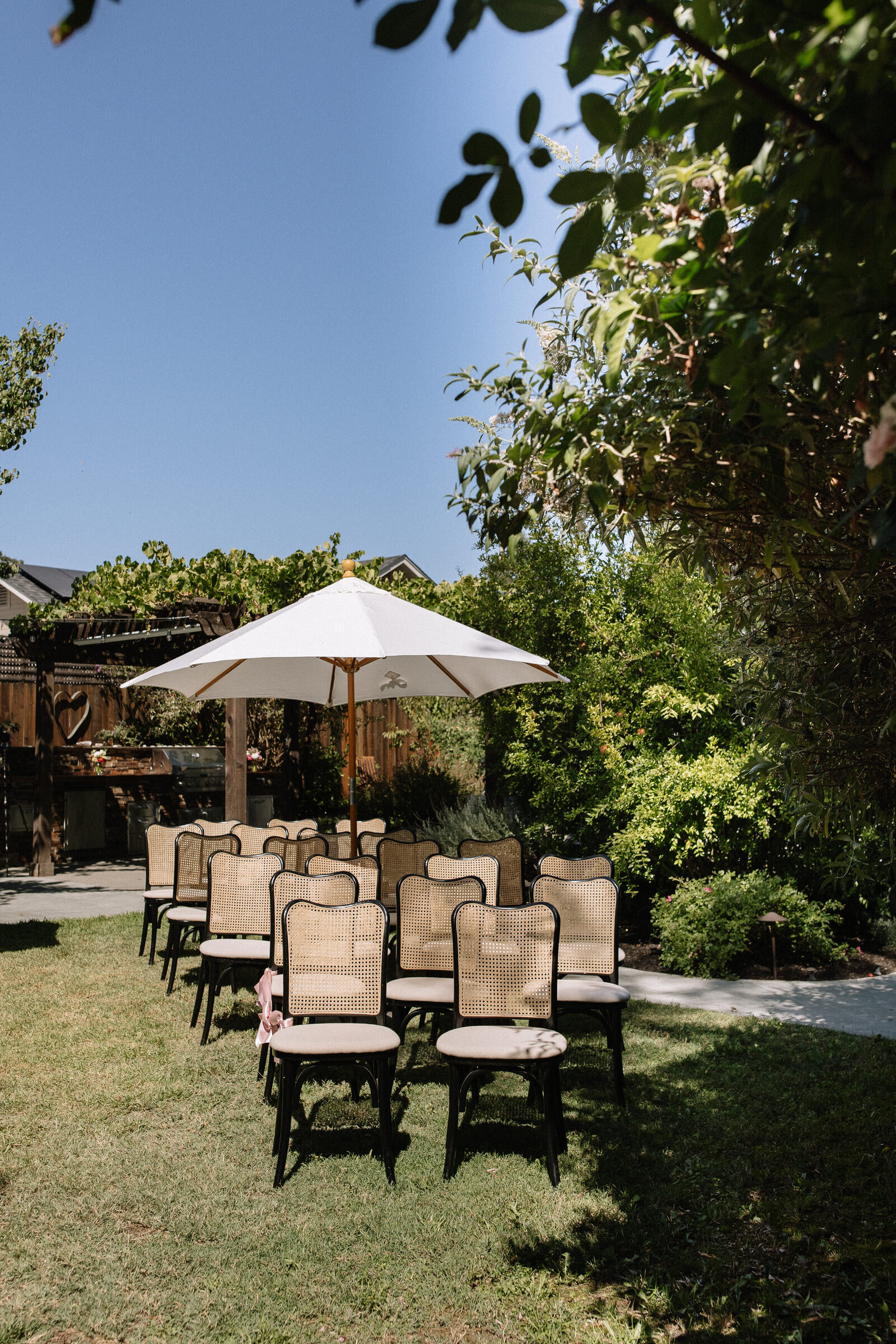Ceremony chairs placed under white umbrellas ahead of outdoor McCall wedding ceremony