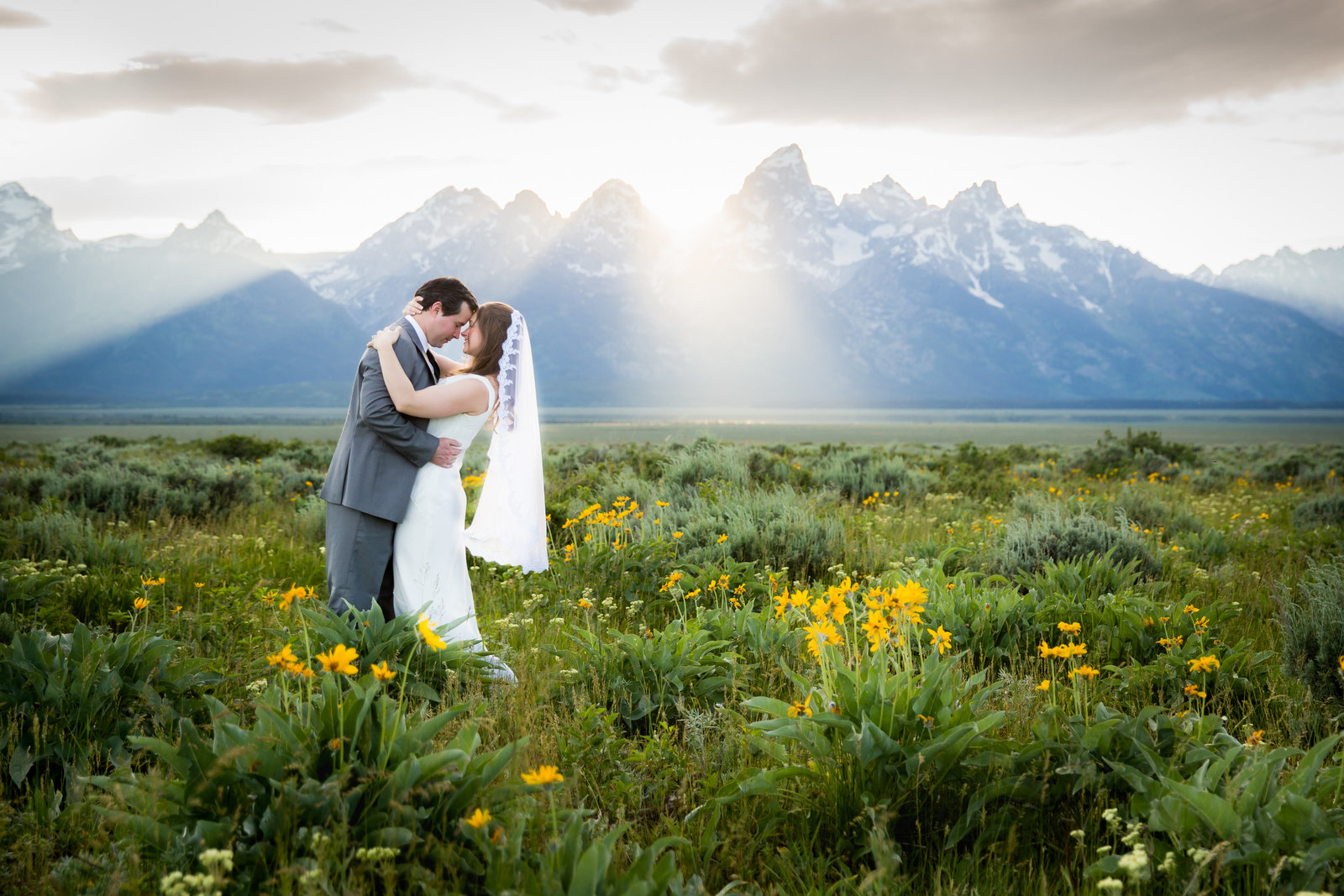 Grand Teton National Park wedding couple in wildflowers at sunset