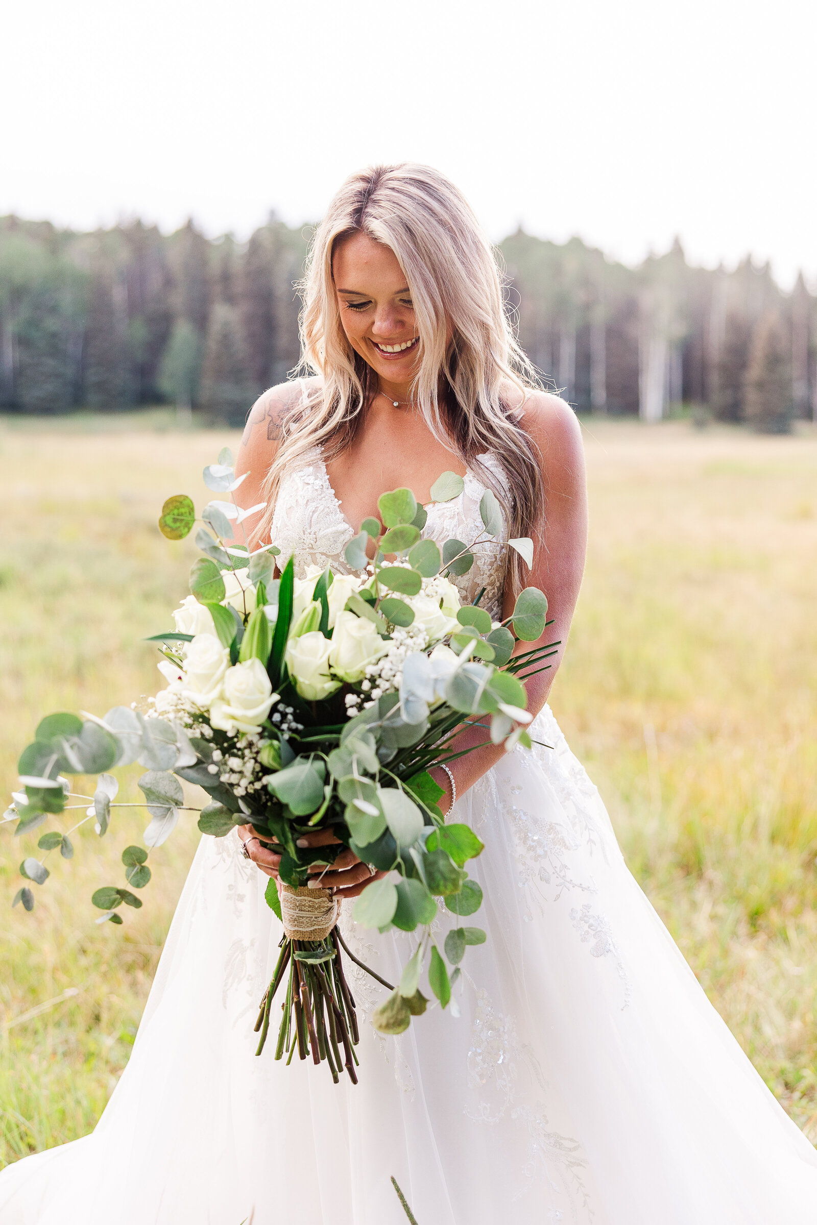 Bridal portrait with bride holding large gorgeous green and white bouquet