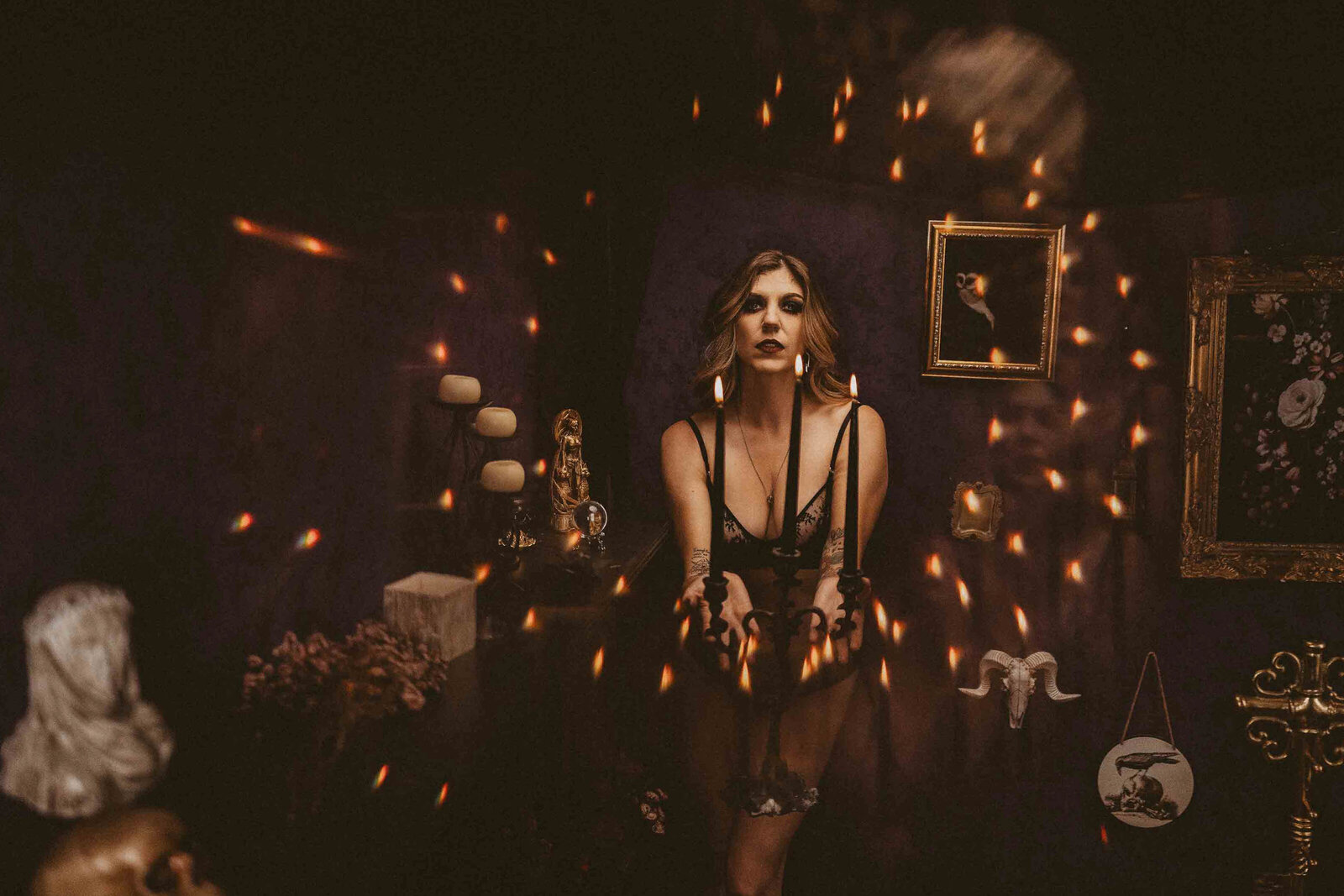 woman in a black lingerie with candles around her