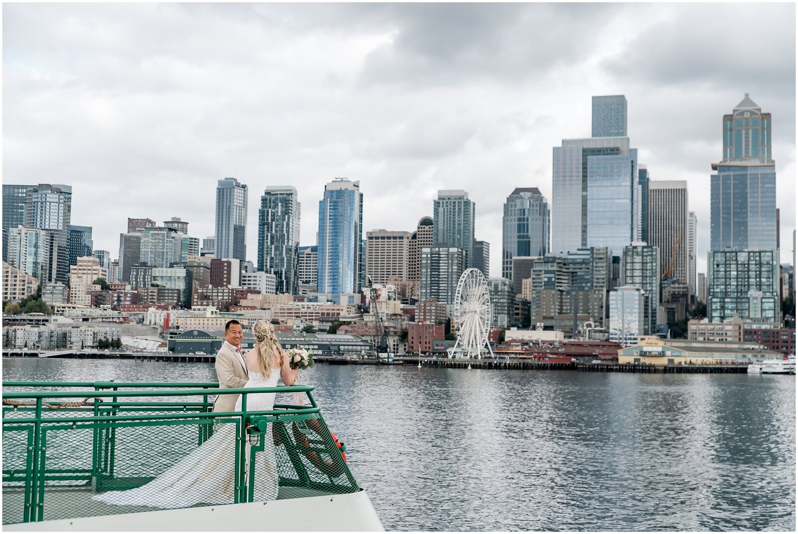 Bride and groom on boat with city skyline behind them