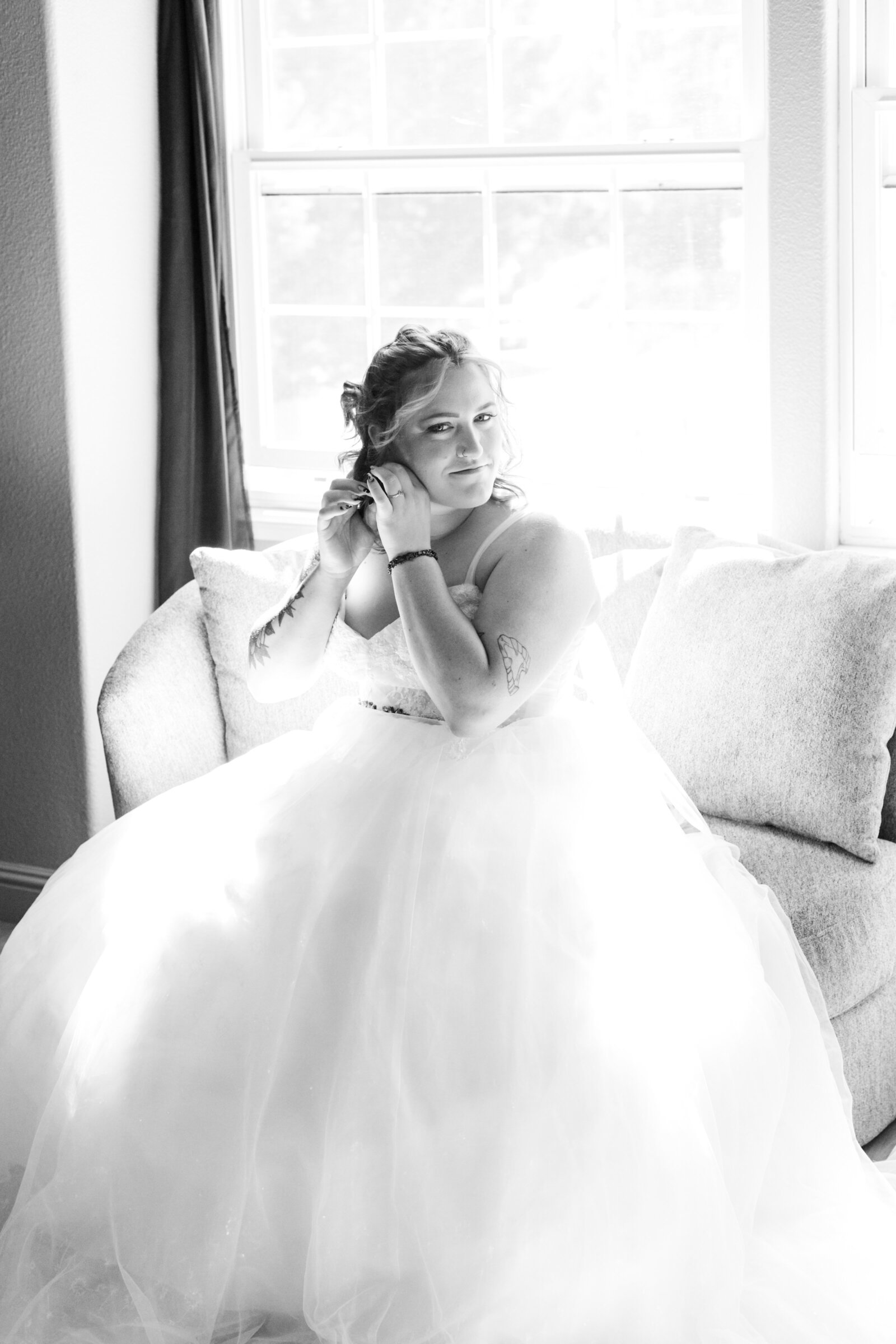 A bride with red hair and tattoos gets ready on her wedding day.
