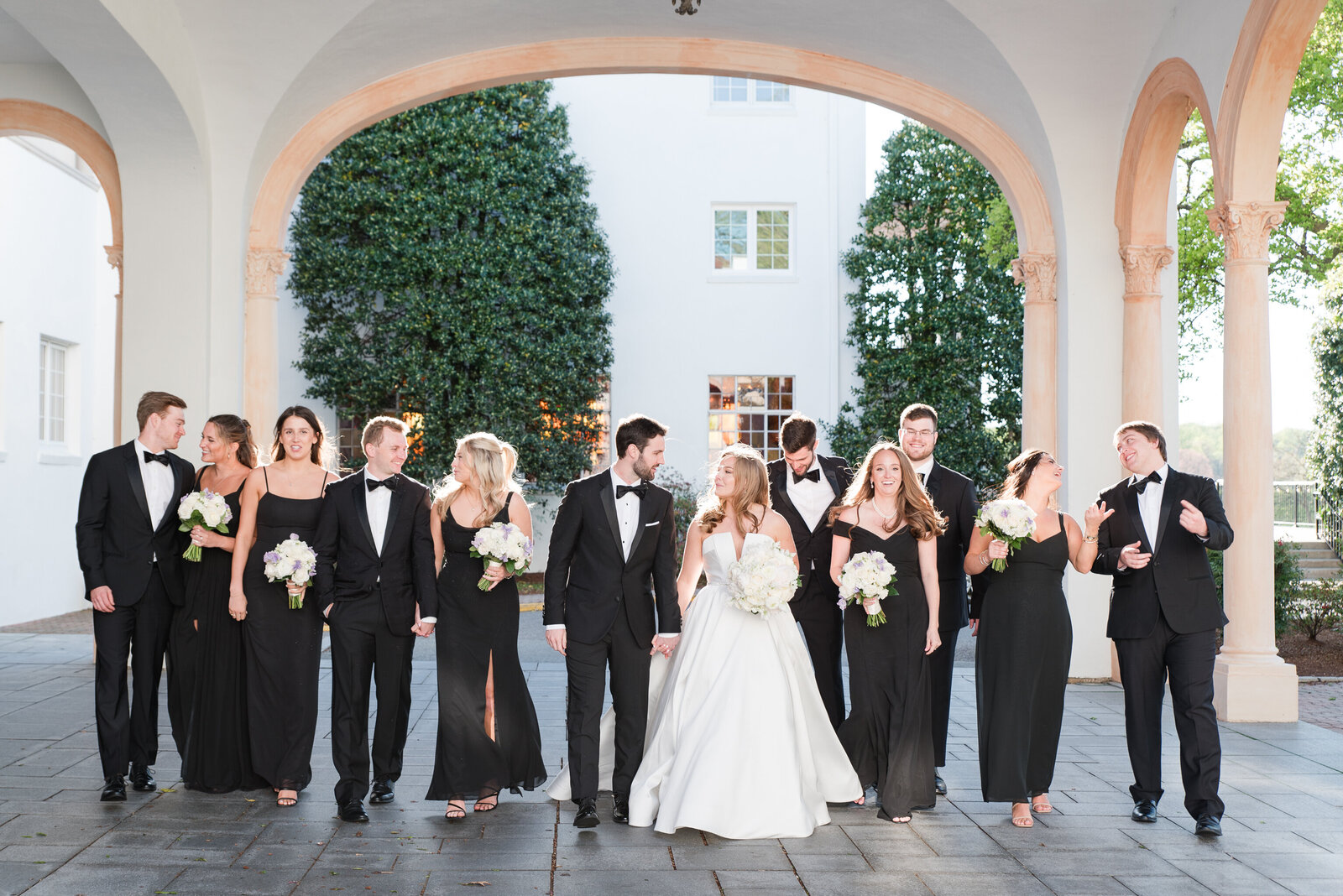 wedding party on country club black tuxes and black bridesmaids dresses