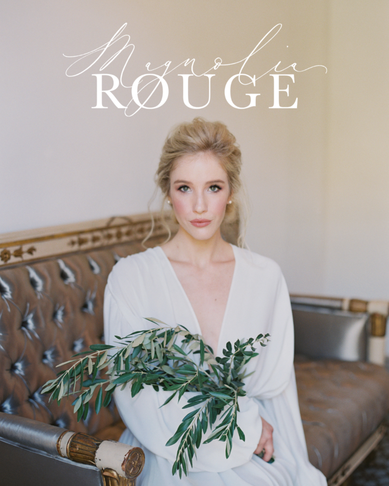 Kohnur fine art bride with soft glam makeup and a delicate updo in an ethereal long-sleeved gown, holding olive branches featured on Magnolia Rouge.