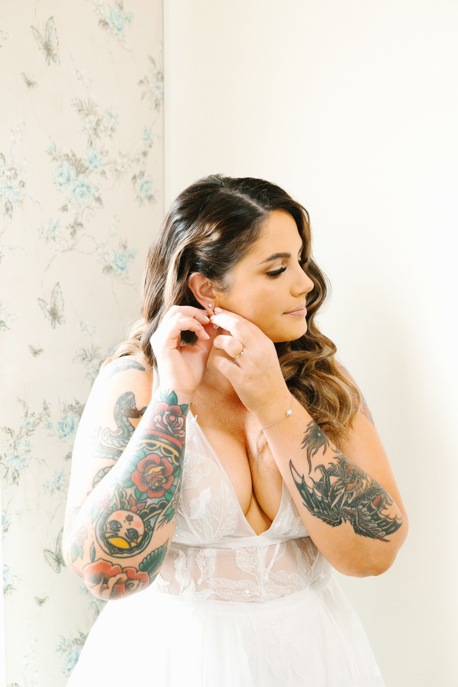 Tattoo bride and groom getting ready for their colorful wedding in Santa Cruz, California.