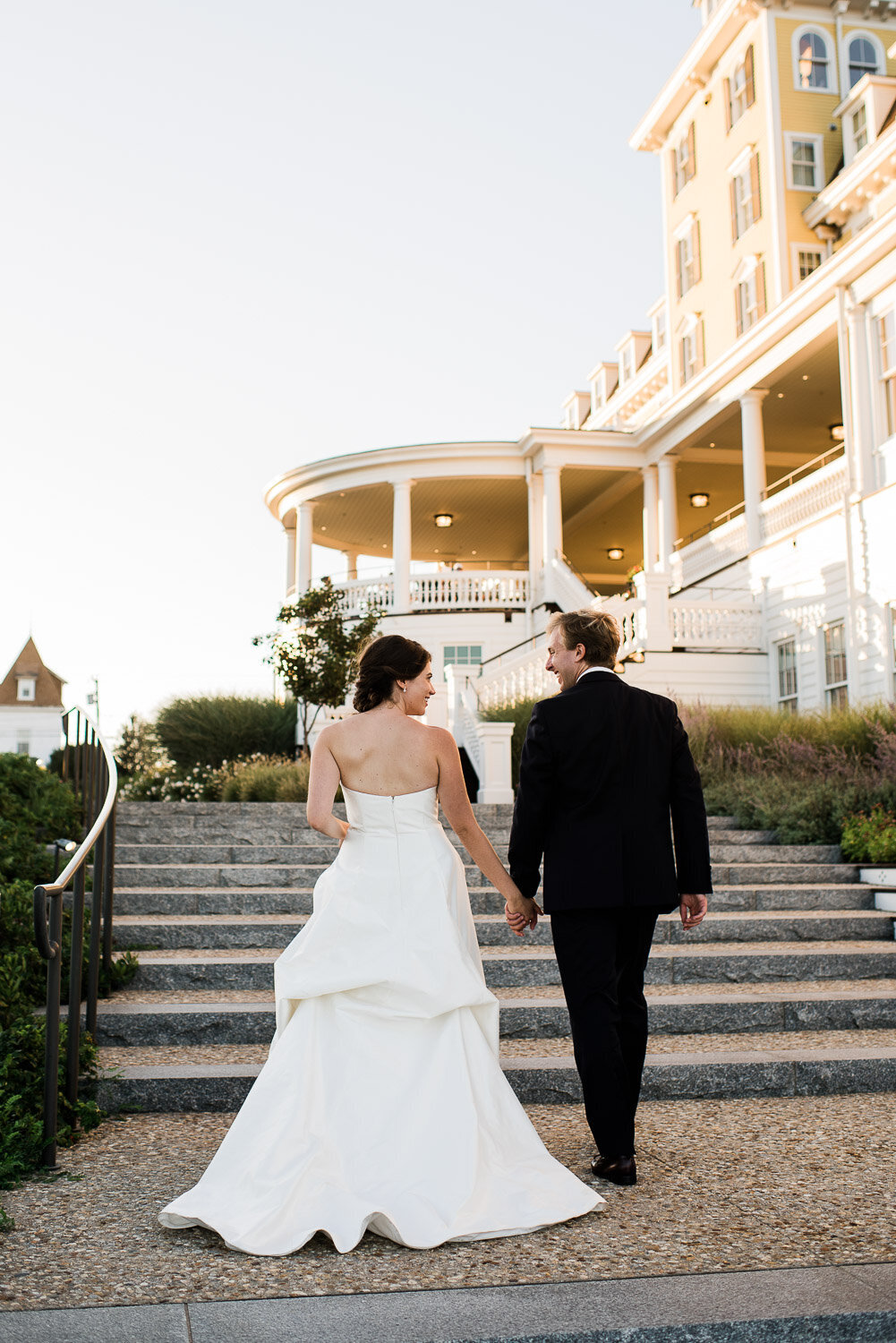 couple walking up steps at Ocean House from behind