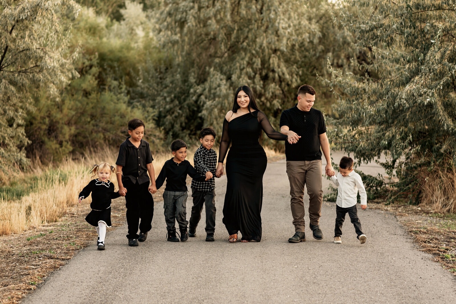 Family walking down the path of Inlet Park for family photoshoot