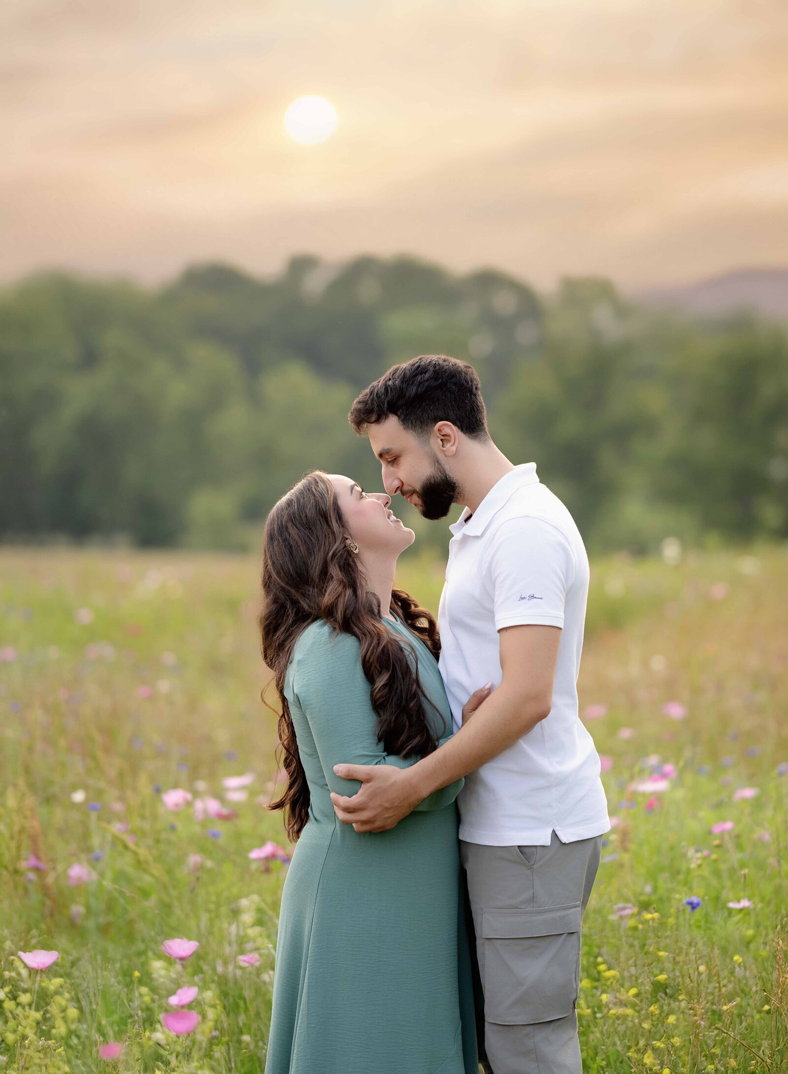 Women and man, standing in wildflower field and looking at each other lovingly. Photo taken at Prospect farms near Atlanta, GA.