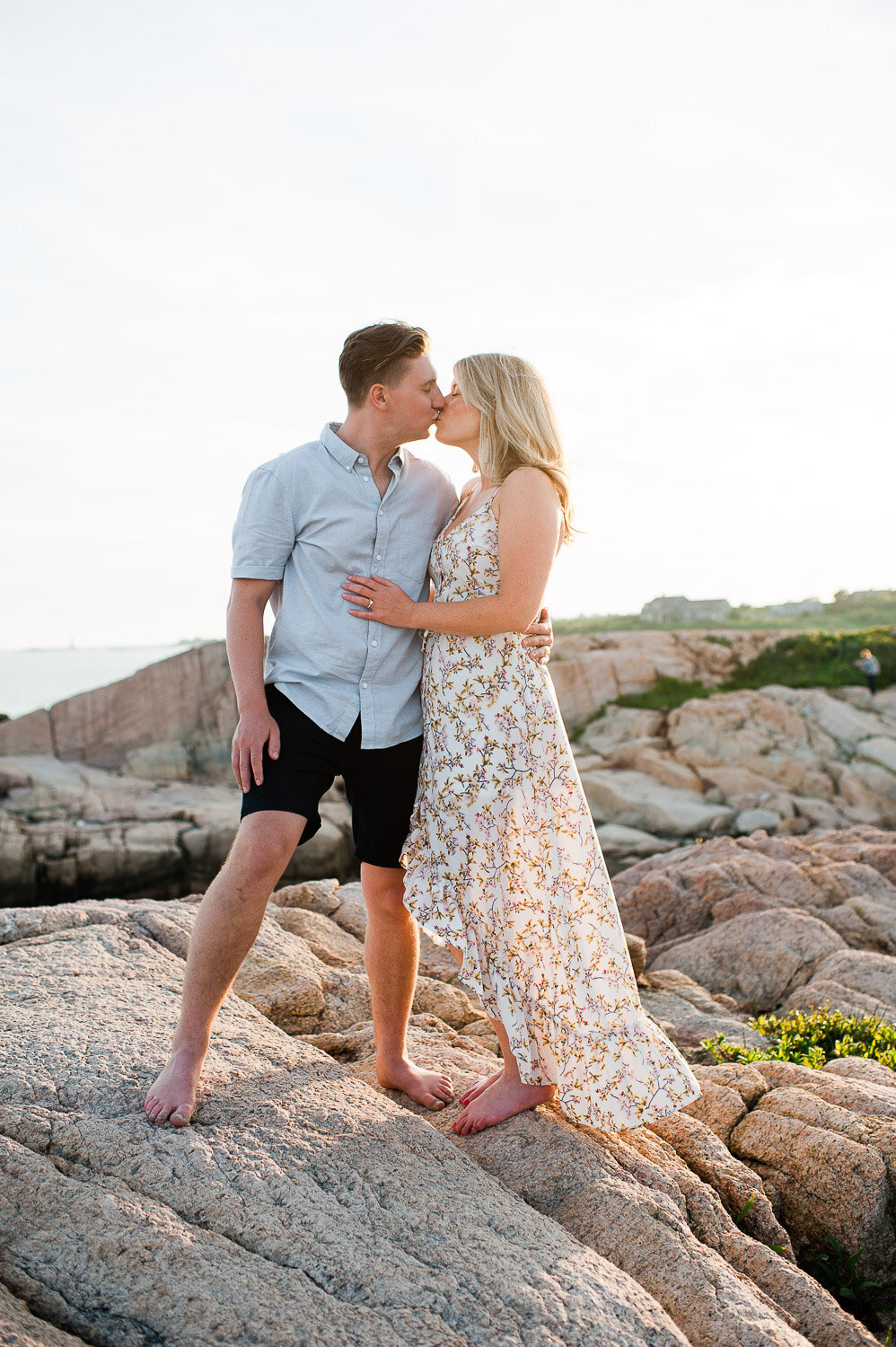 couple standing kiss on rocks