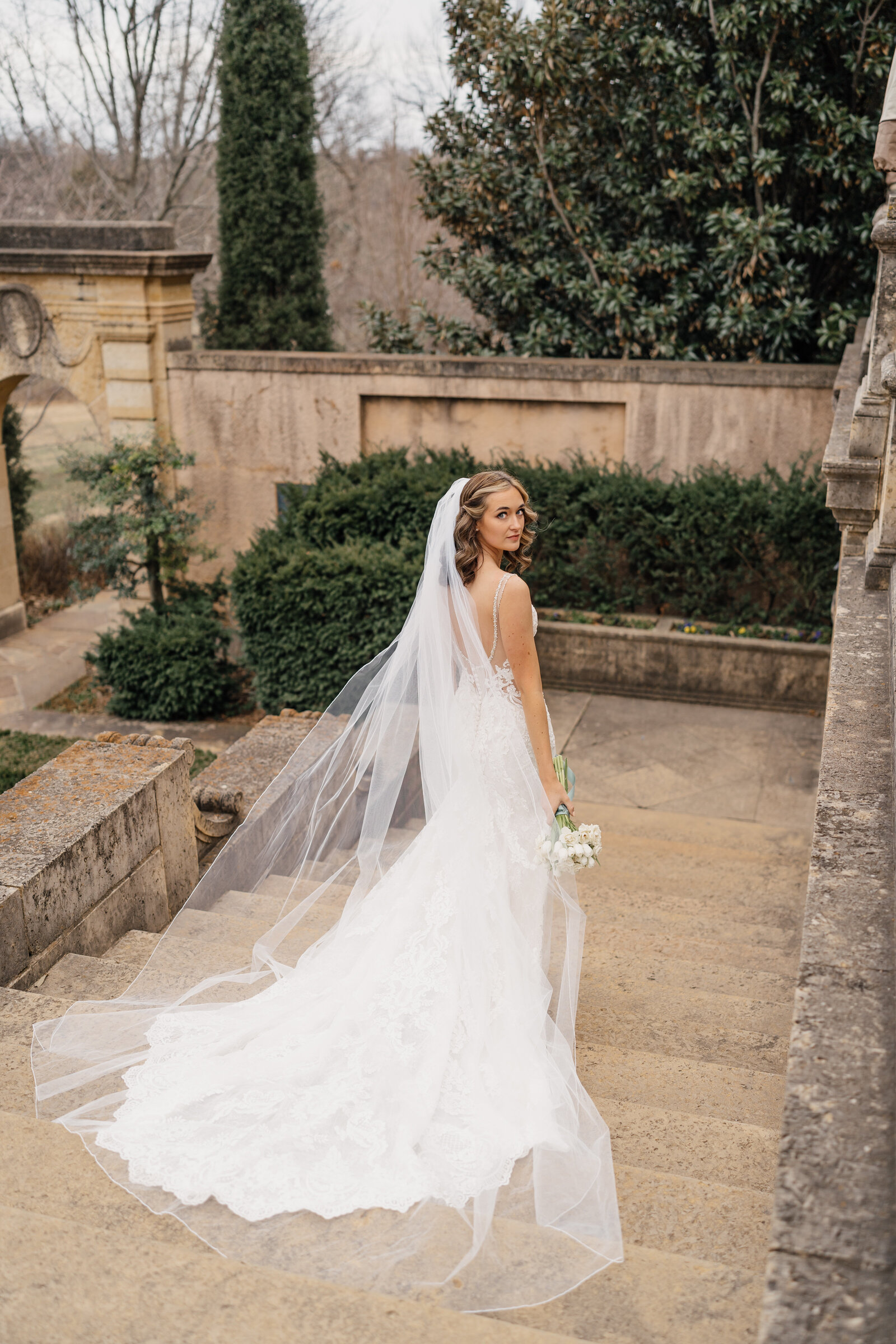 Bride walking down the aisle inside The Philbrook Museum of Art’s grand interior, surrounded by art and history.