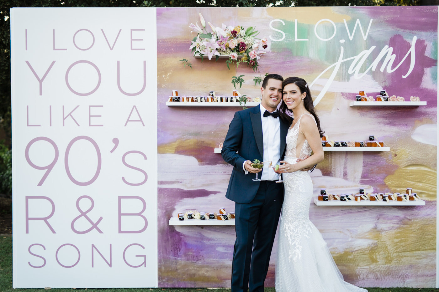 Couple in front of their custom escort display at San Diego venue Rancho Valencia captured by photographer My Sun and Stars Co