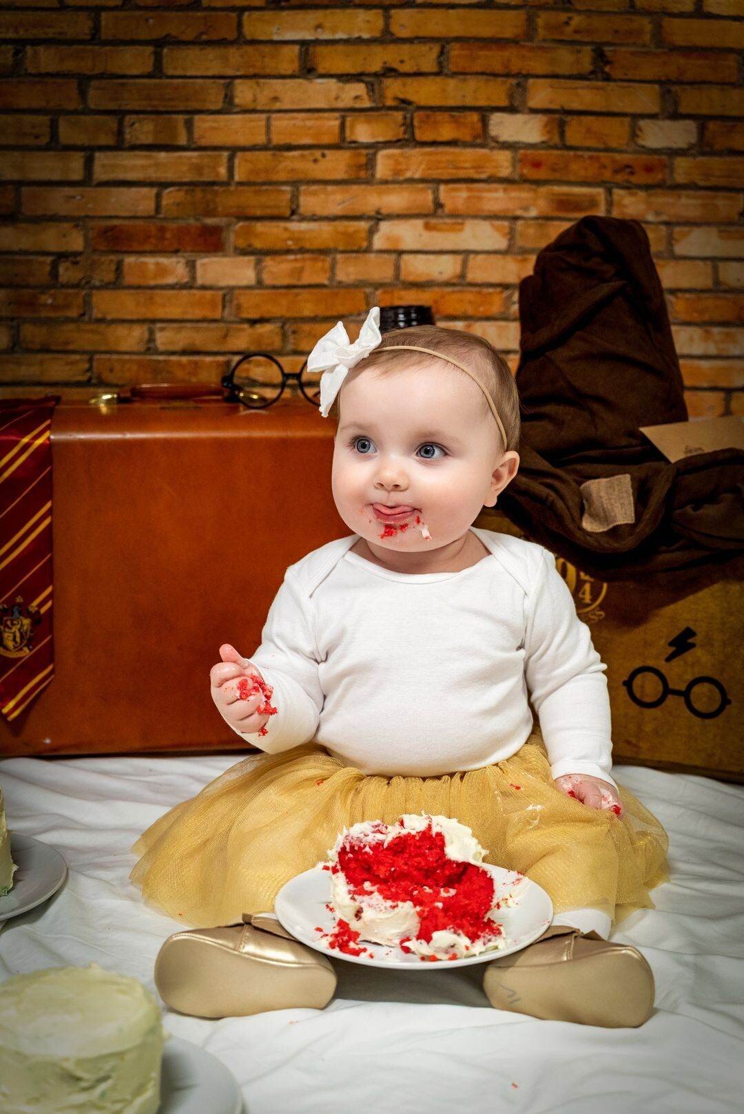 Baby girl having her cake smash
