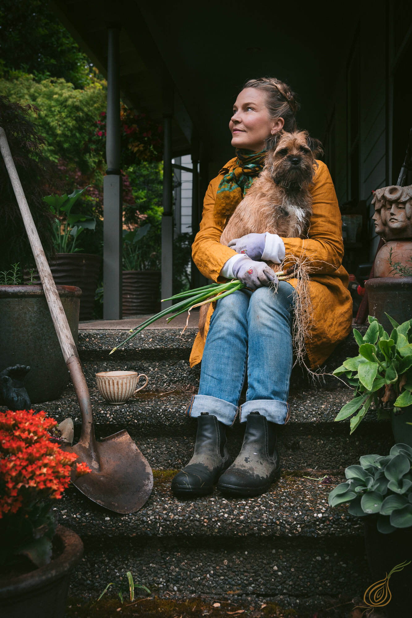 A woman relaxes on steps, accompanied by her dog, creating a serene and heartwarming scene.