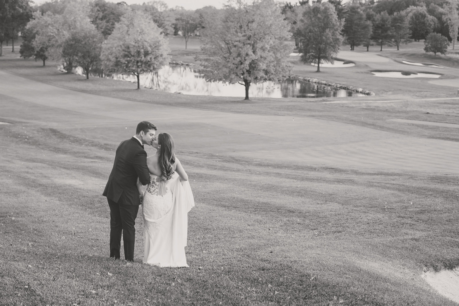 bride and groom walking the grounds at Glen Head Country Club