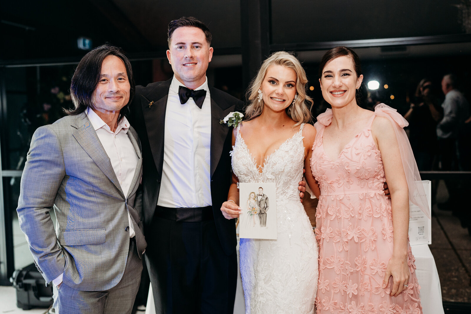 artist-posing-with-wedding-couple-displaying-their-illustration