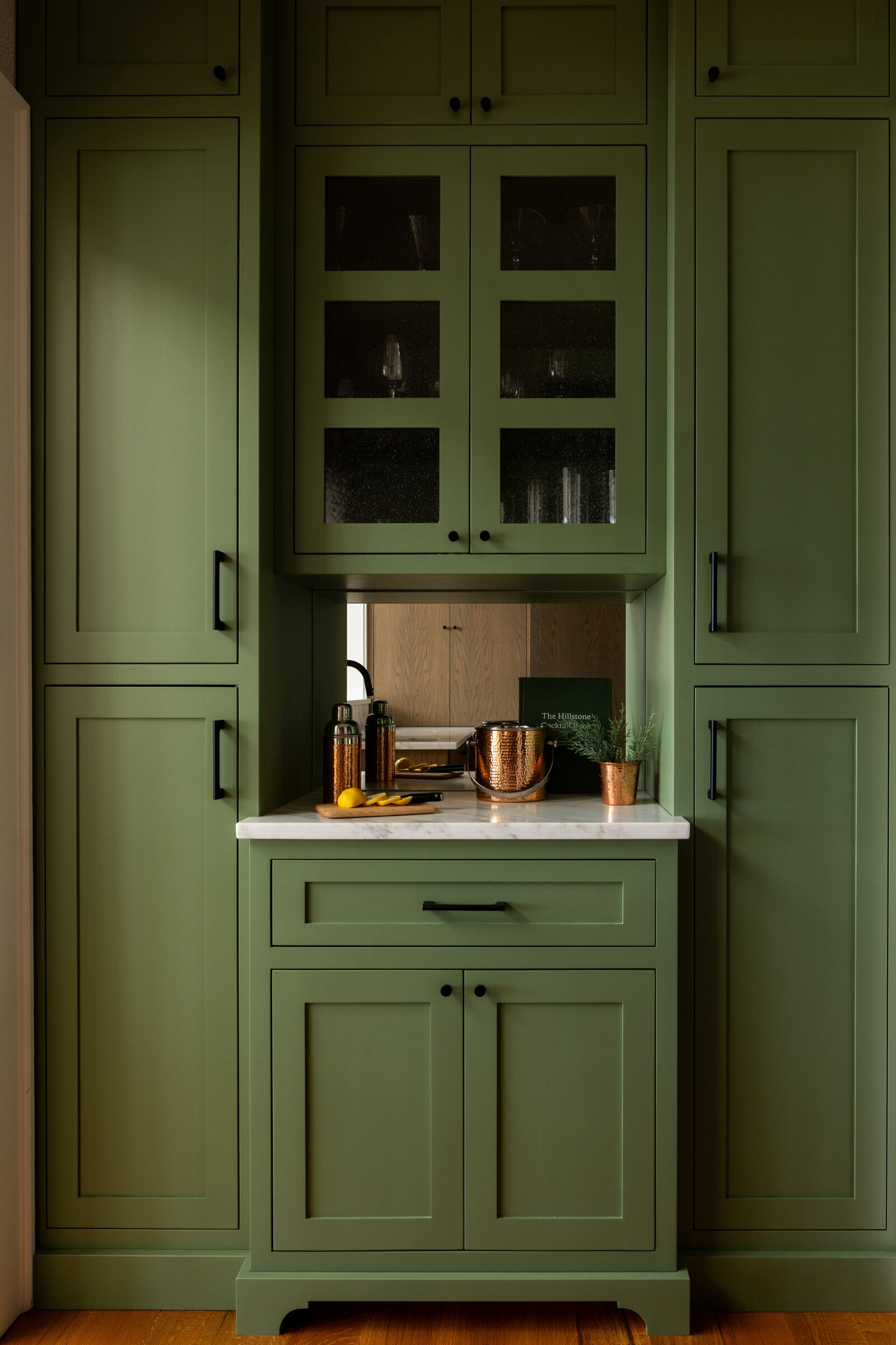 CUSTOM BAR WITH GREEN PAINT AND MIRRORED BACKSPLASH