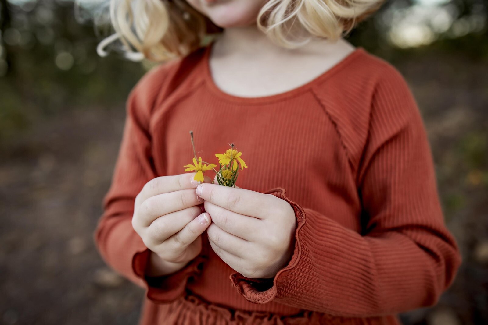 a child holding a wildflower in Grapevine Texas