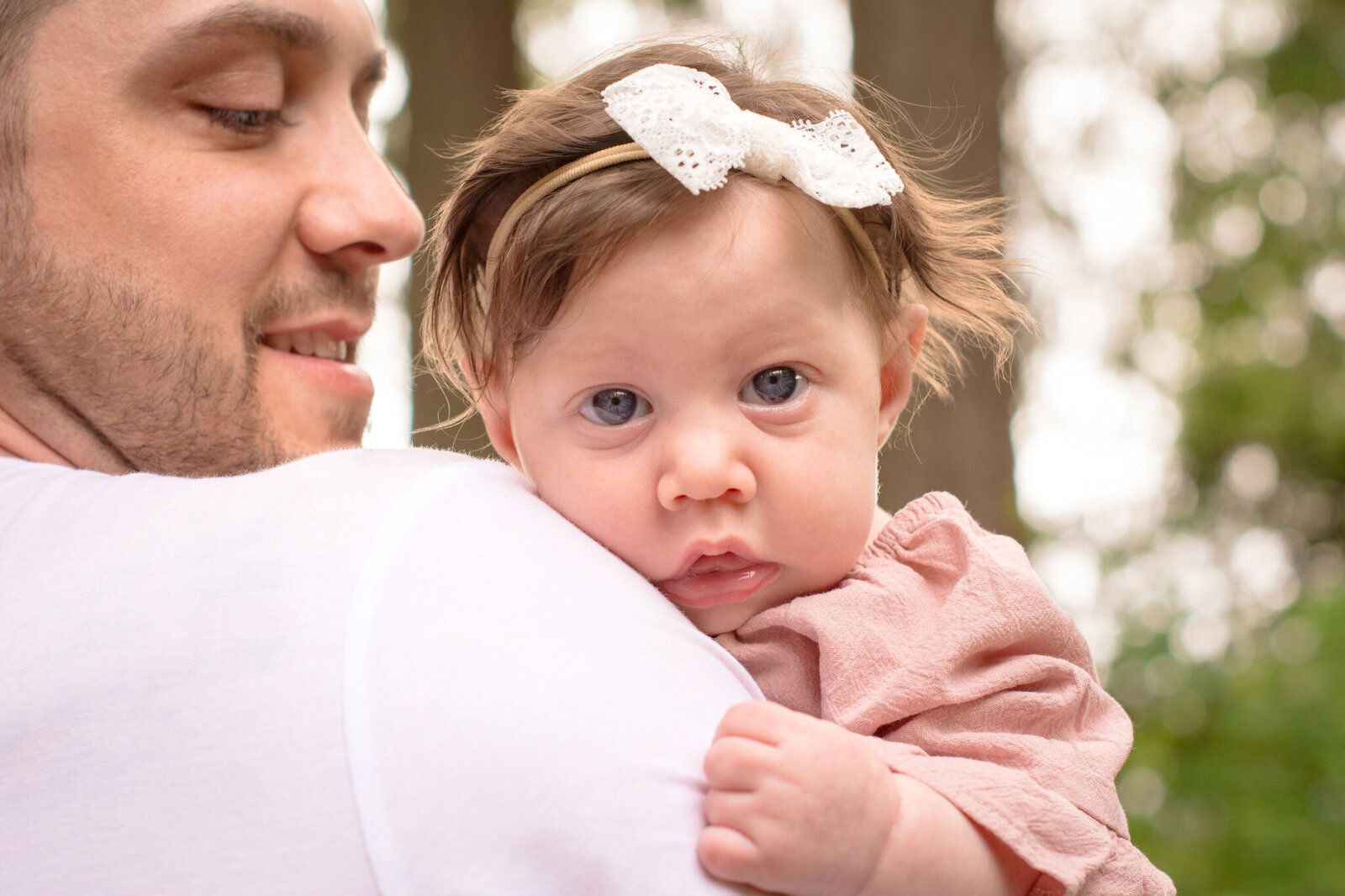 Dad holding baby girl at Pine Lake Park