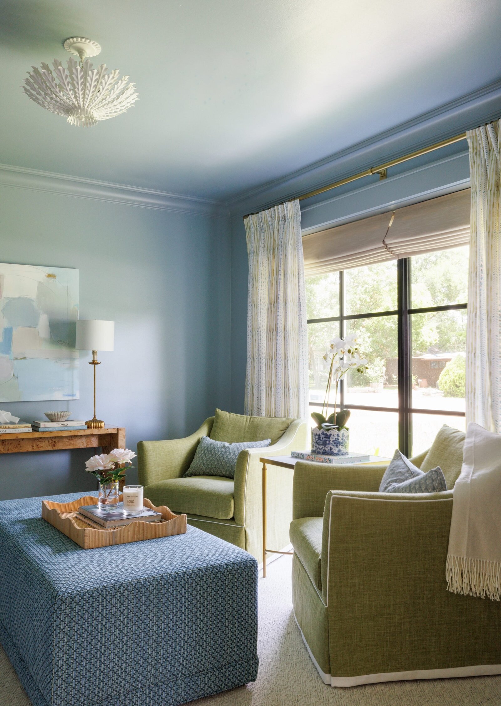 vision and hammer interior design sitting area with large window and curtains with blue and green accents