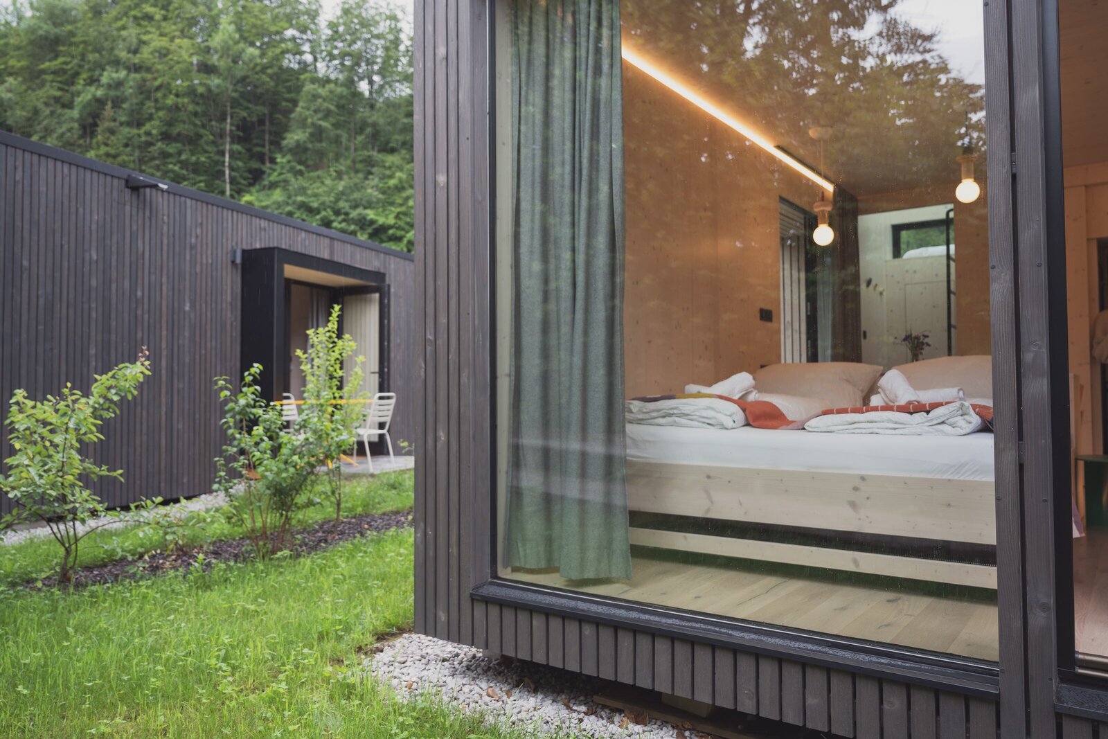 View of a queen bed inside a Tiny Home at The Campus Alps.com, offering a comfortable and relaxing retreat