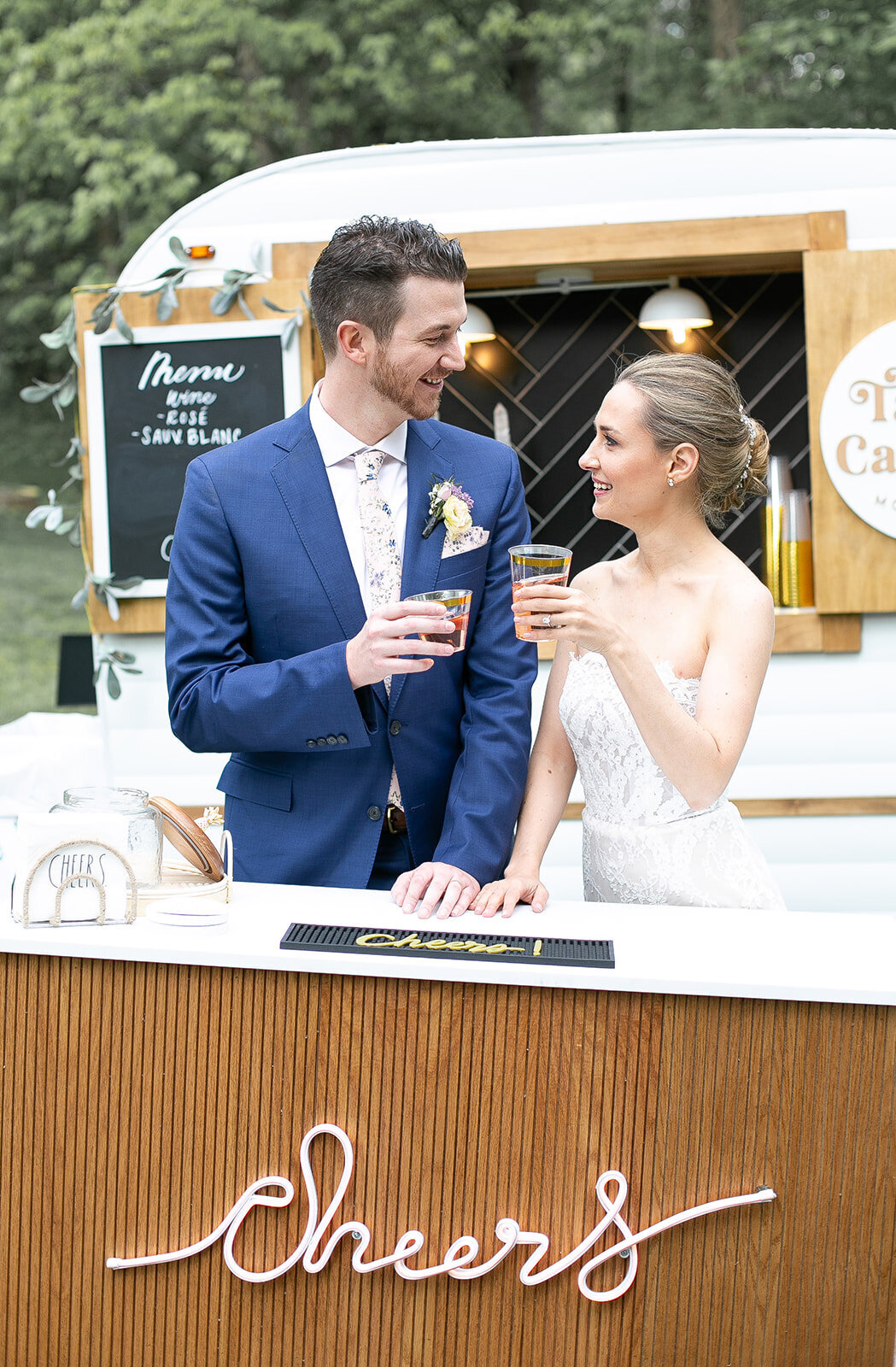 bride and groom cheering a drink together