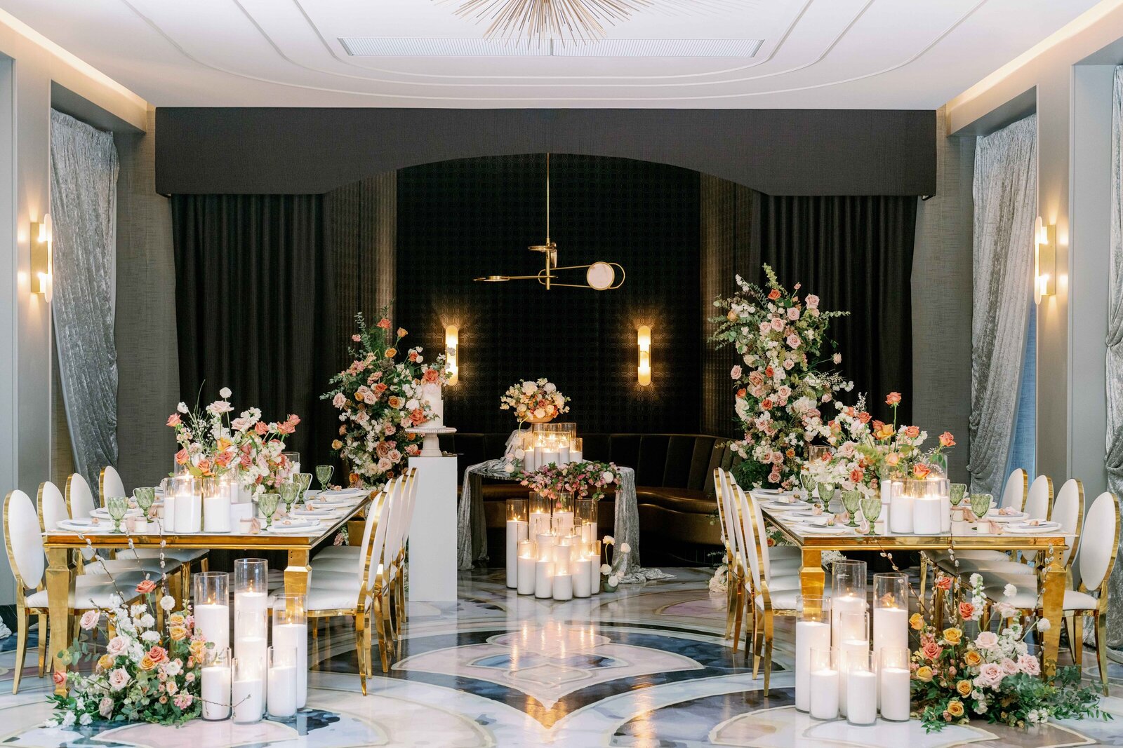 wide shot of a white wedding venue with black tables and white chairs