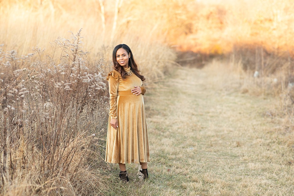 Pregnant woman in gold dress in a field by Maryland Maternity Photographer : Rebecca Leigh Photography